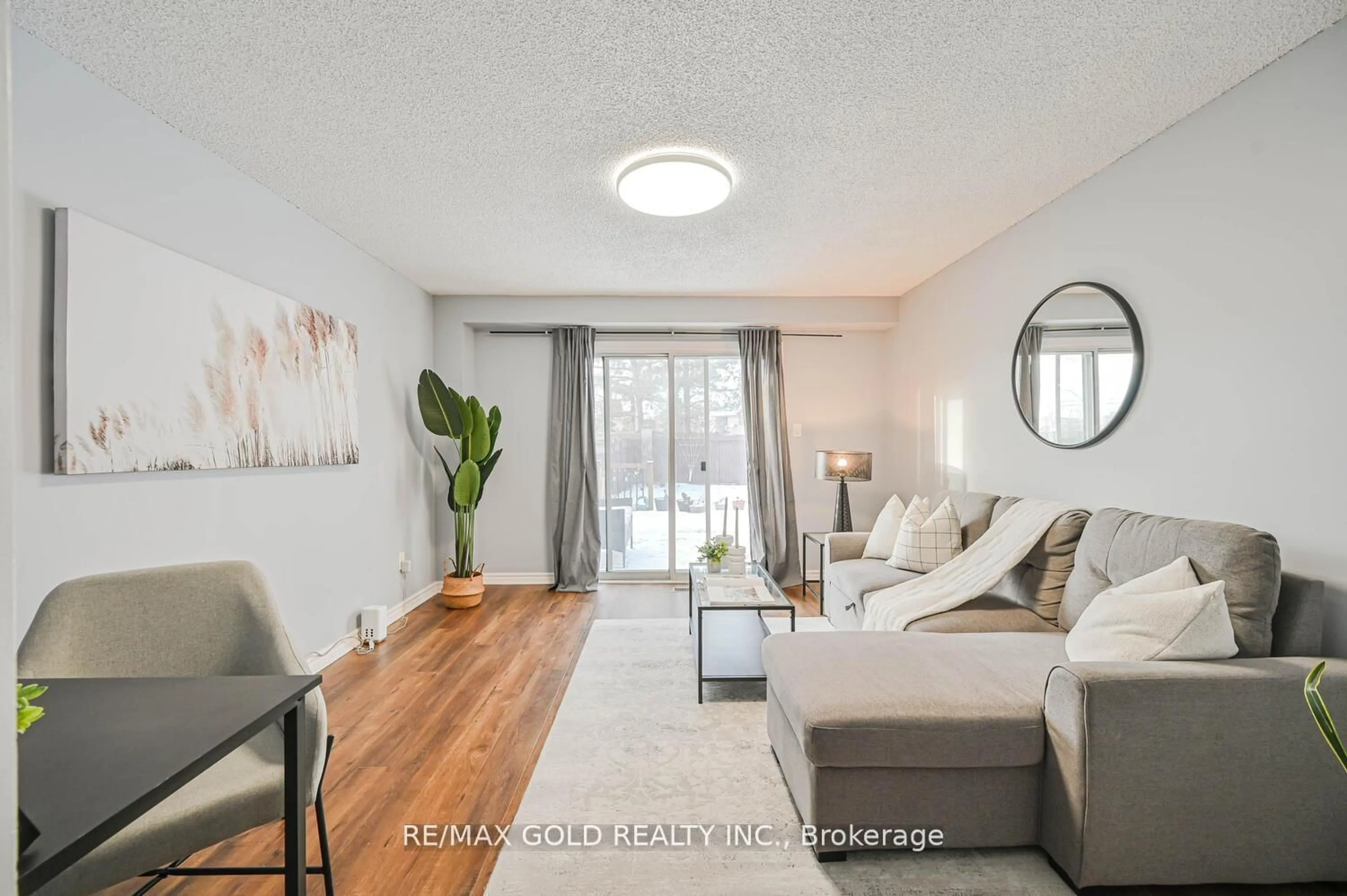 Living room with furniture, wood/laminate floor for 73 Chipmunk Cres, Brampton Ontario L6R 1B4