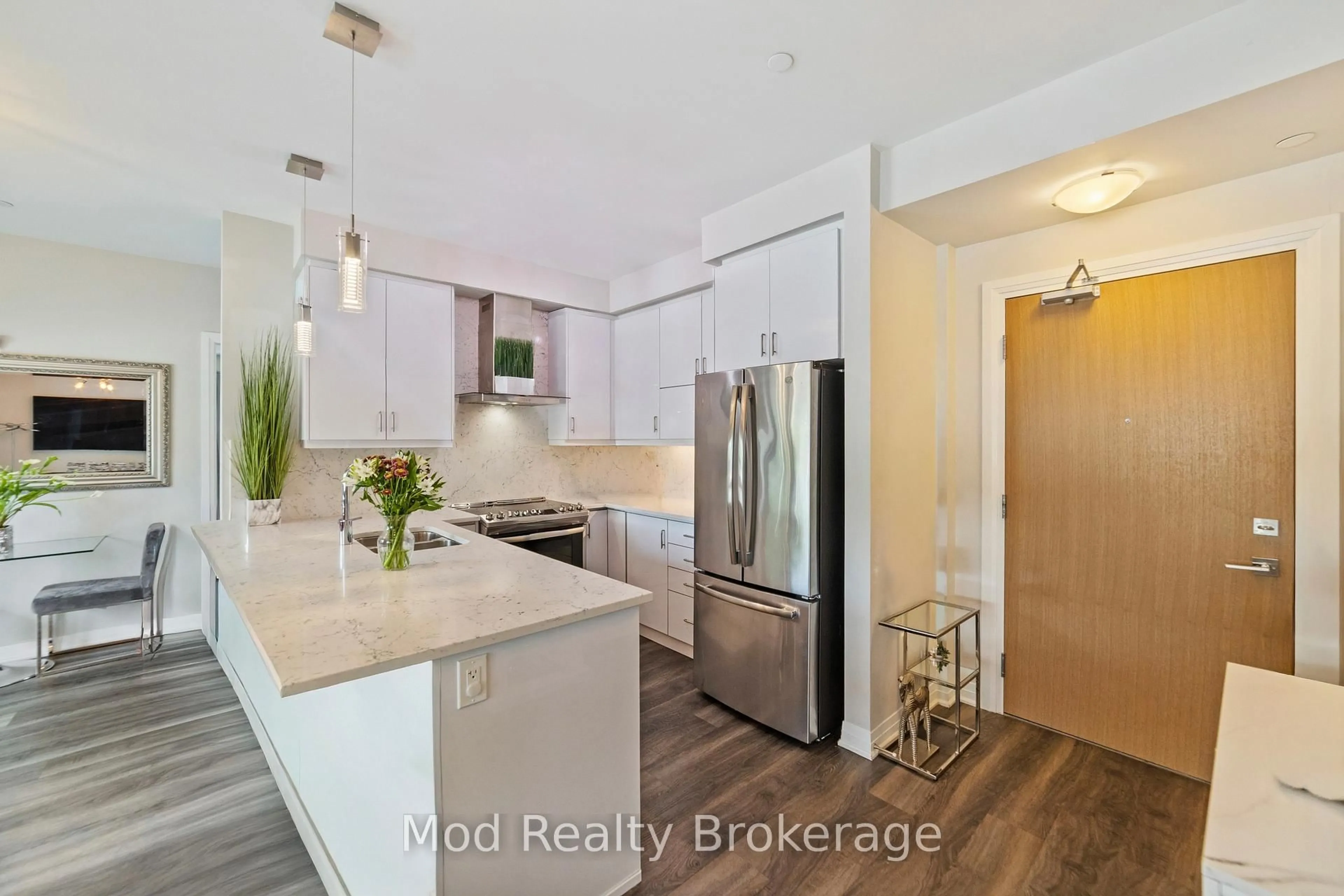 Open concept kitchen, wood/laminate floor for 128 Grovewood Common #129, Oakville Ontario L6H 0X3