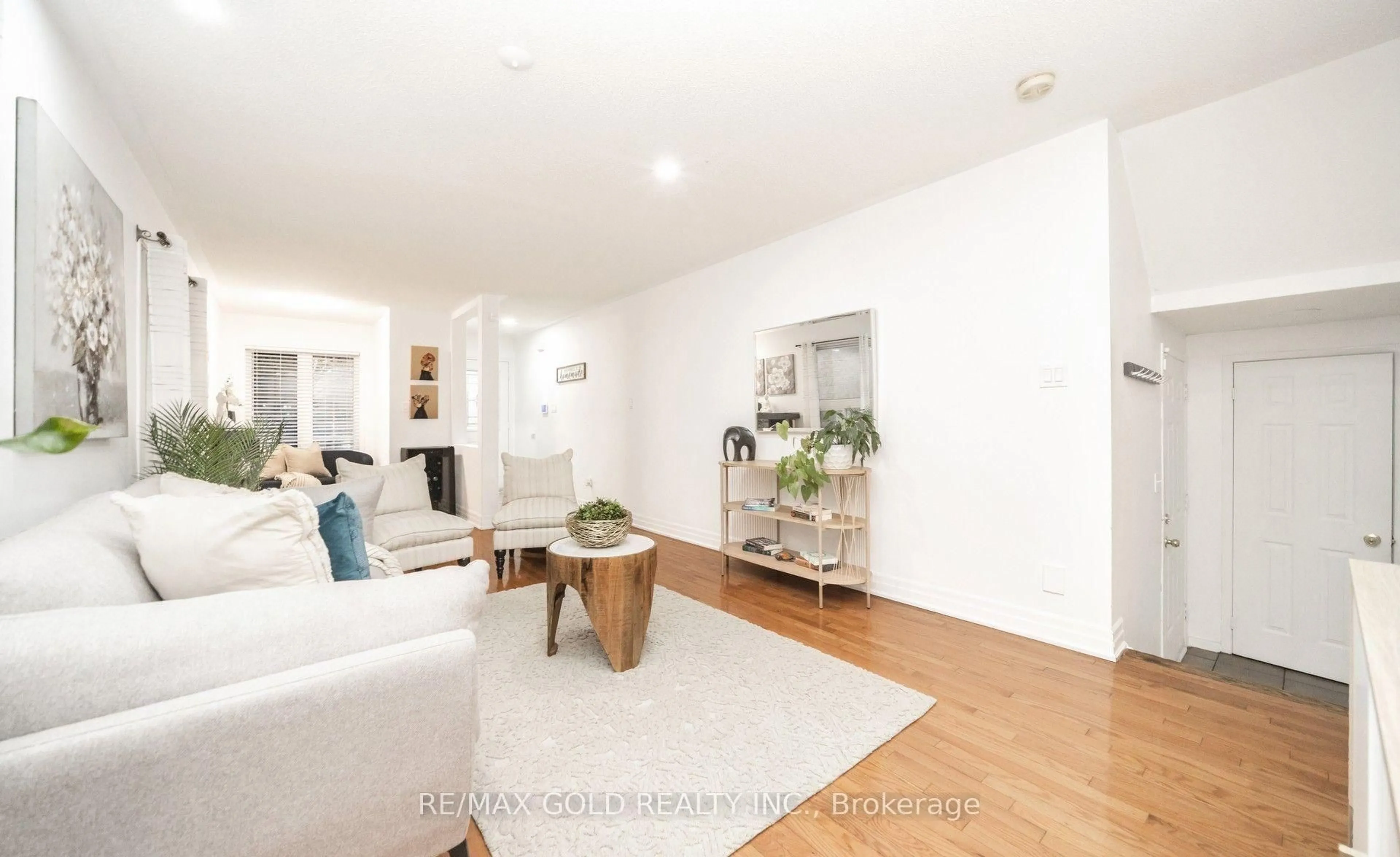 Living room with furniture, wood/laminate floor for 36 Roxton Cres, Brampton Ontario L7A 2A9