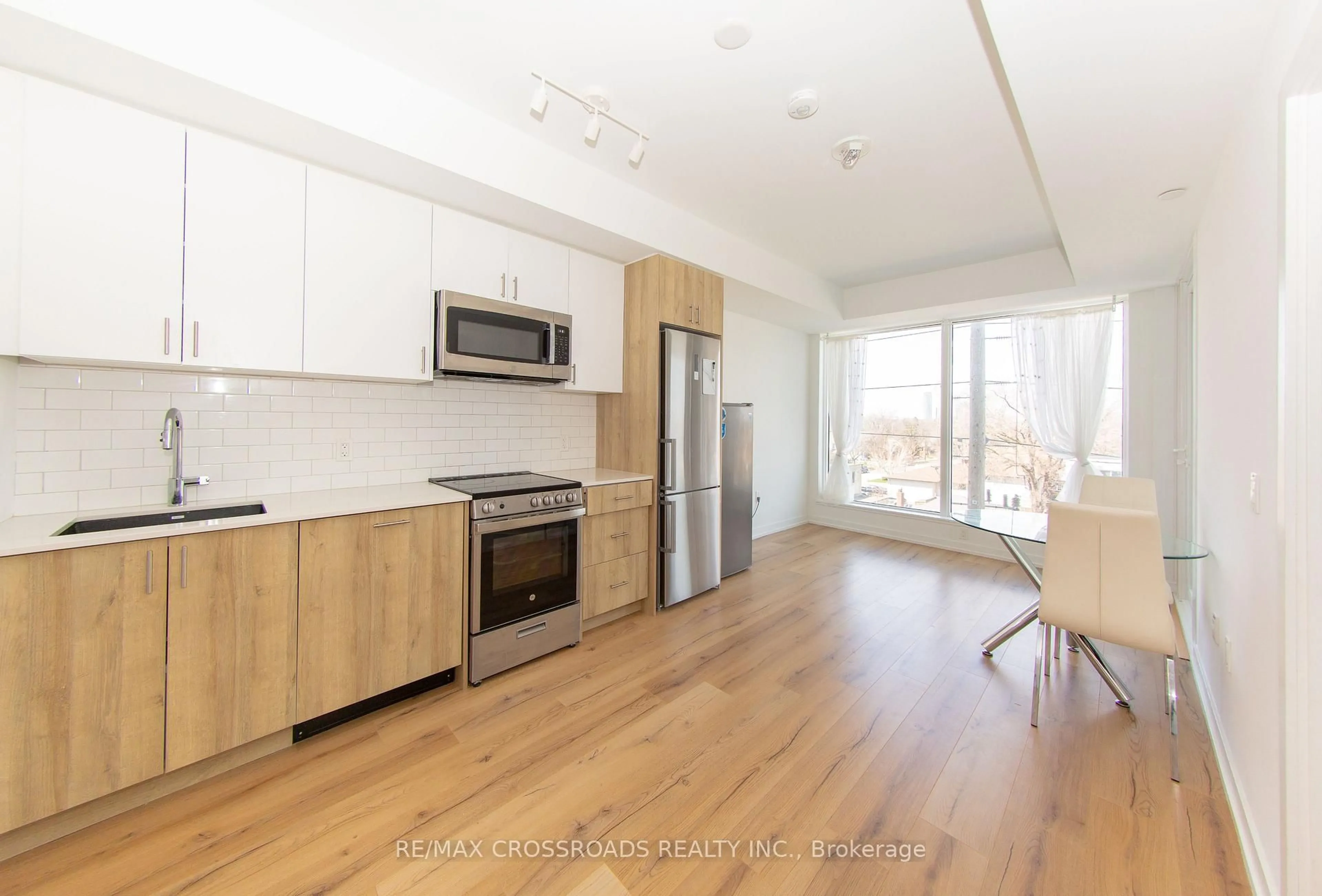 Open concept kitchen, wood/laminate floor for 1195 The Queensway #406, Toronto Ontario M8Z 1R6