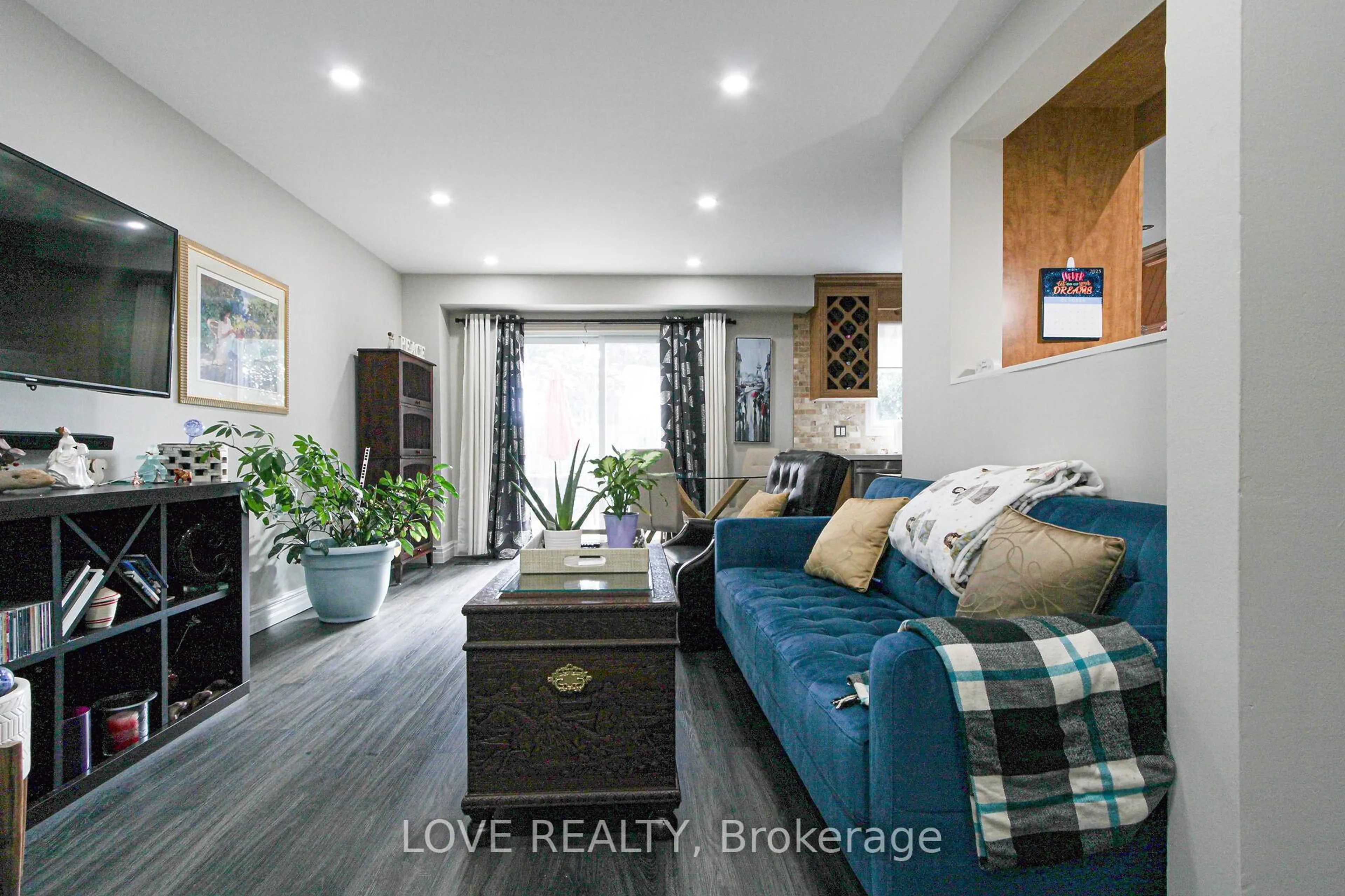 Living room with furniture, wood/laminate floor for 2440 Bromsgrove Rd #90, Mississauga Ontario L5J 4J7