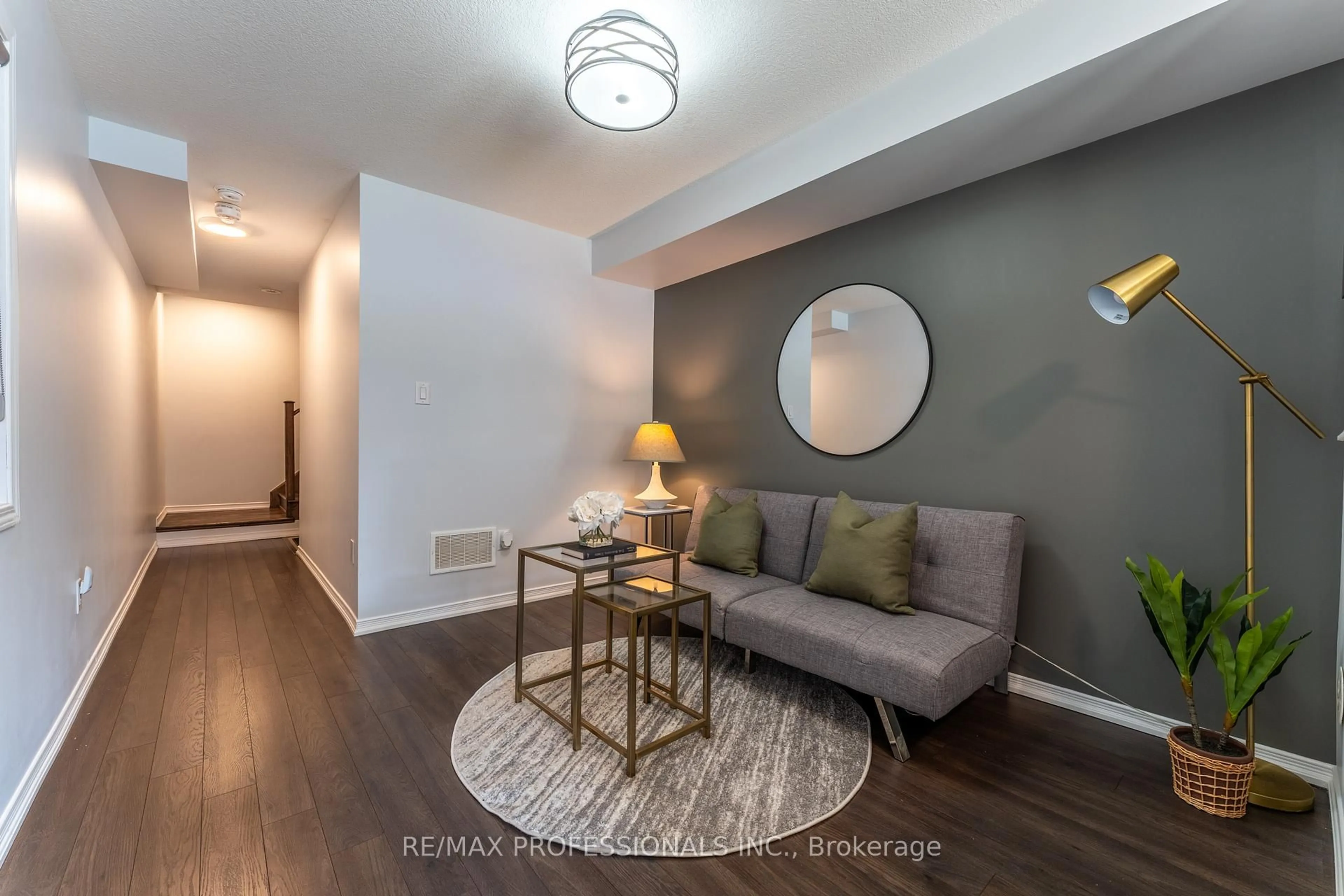 Living room with furniture, wood/laminate floor for 11 Givemay St, Brampton Ontario L7A 0C7