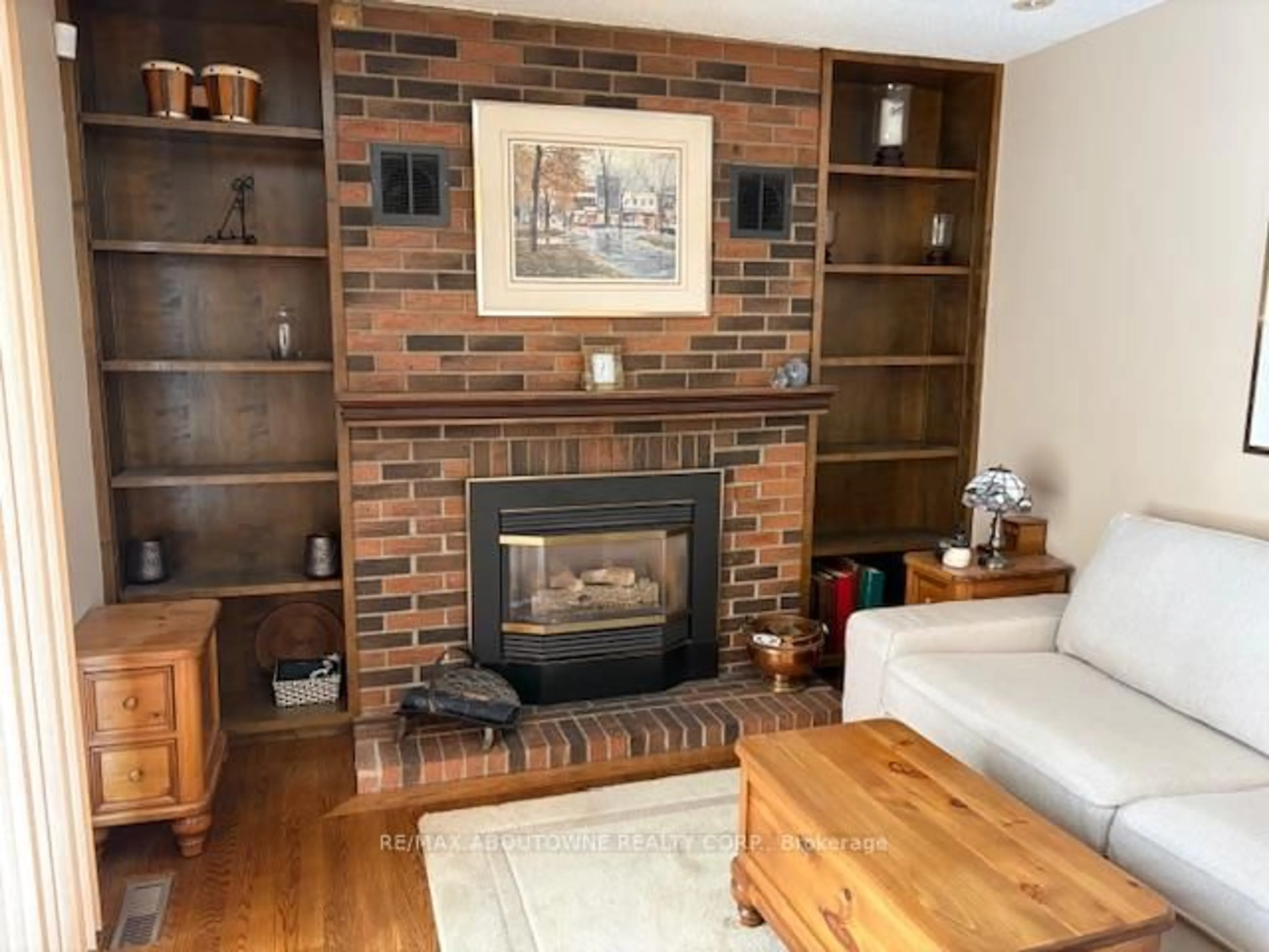 Living room with furniture, wood/laminate floor for 2179 Maplewood Dr, Burlington Ontario L7R 2C7