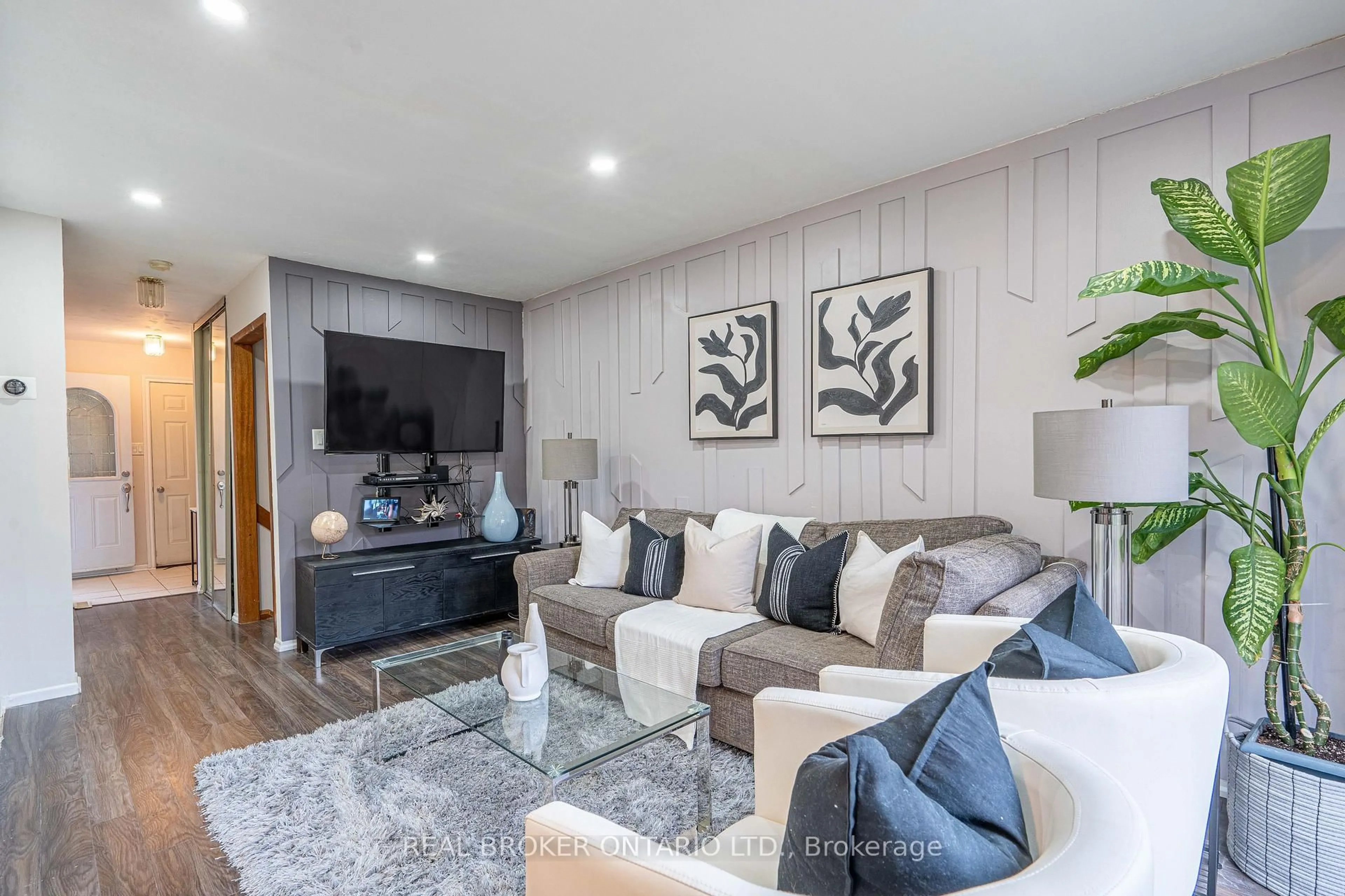 Living room with furniture, wood/laminate floor for 27 Kingswood Dr, Brampton Ontario L6V 2X5