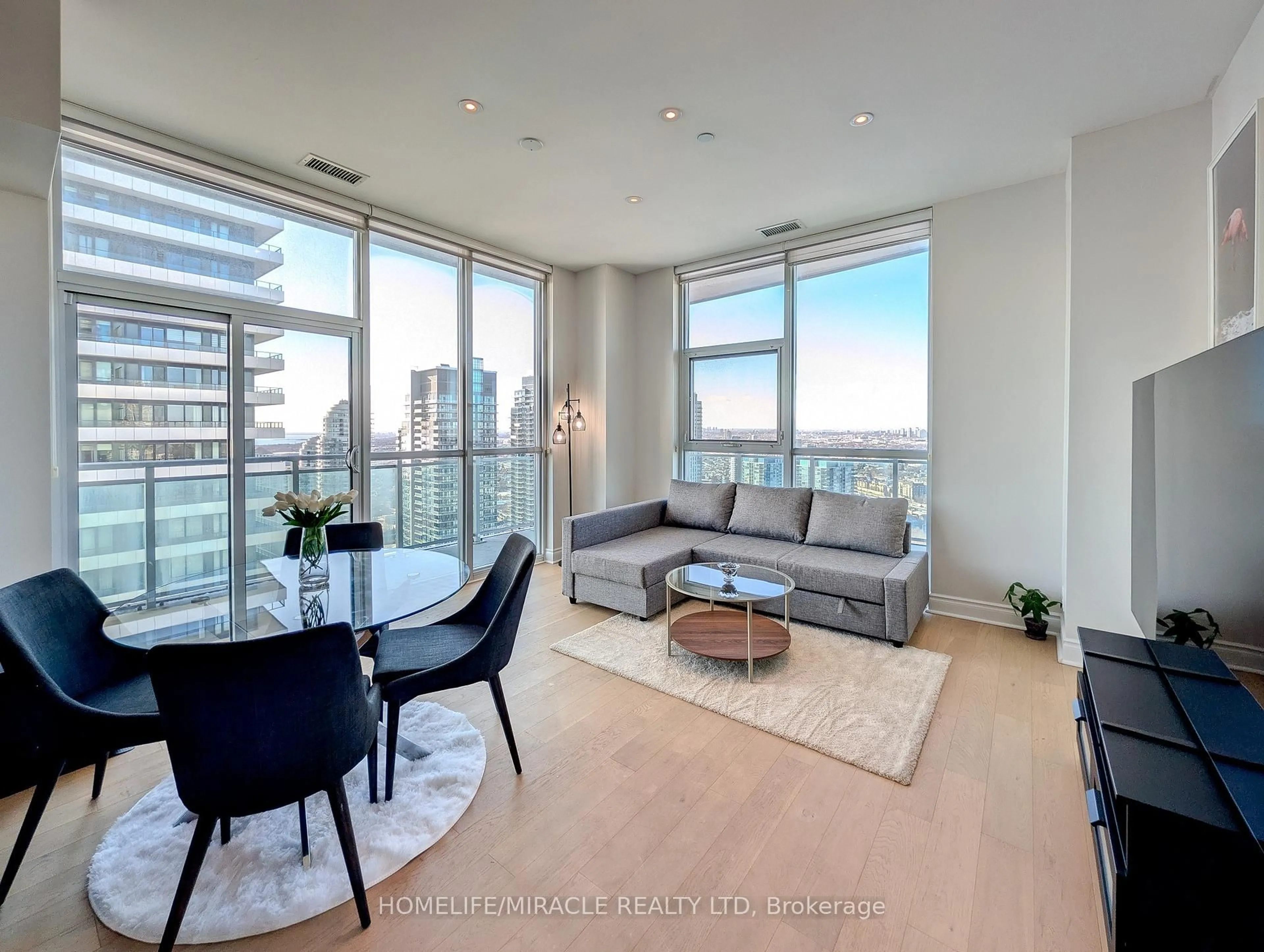 Living room with furniture, wood/laminate floor for 33 Shore Breeze Dr #LPH3802, Toronto Ontario M8V 0G1