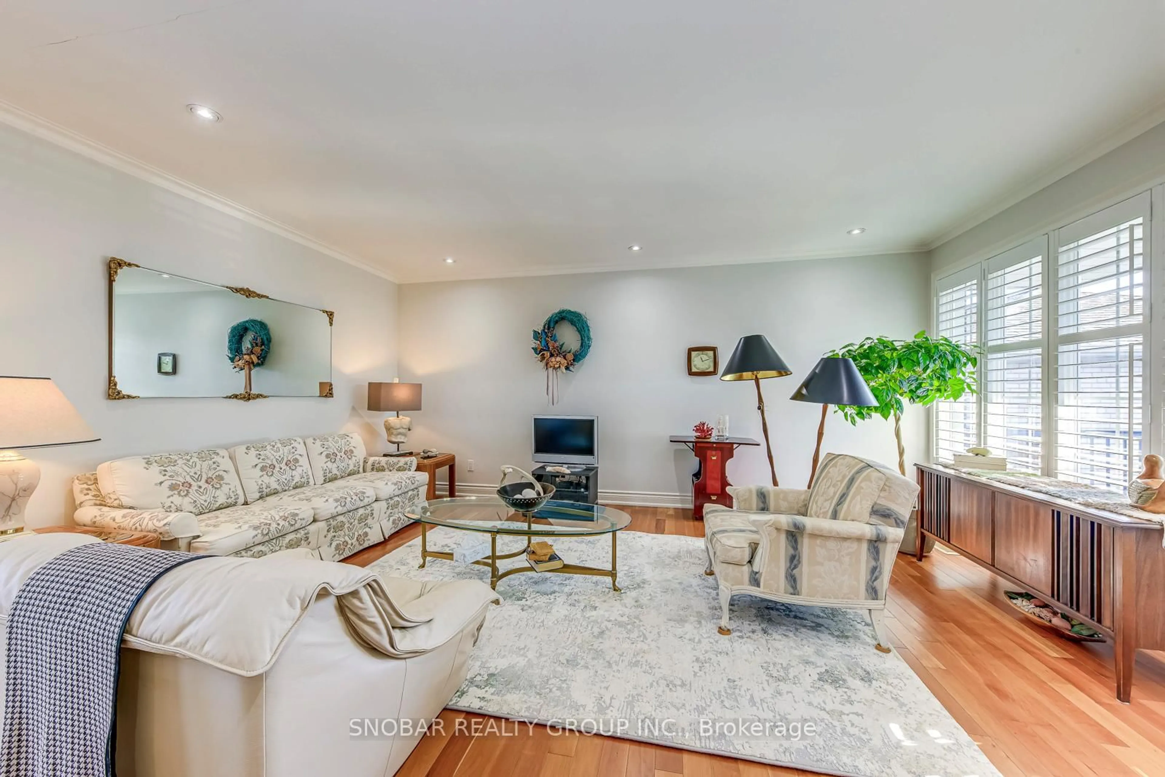 Living room with furniture, wood/laminate floor for 232 La Rose Ave, Toronto Ontario M9P 1B5