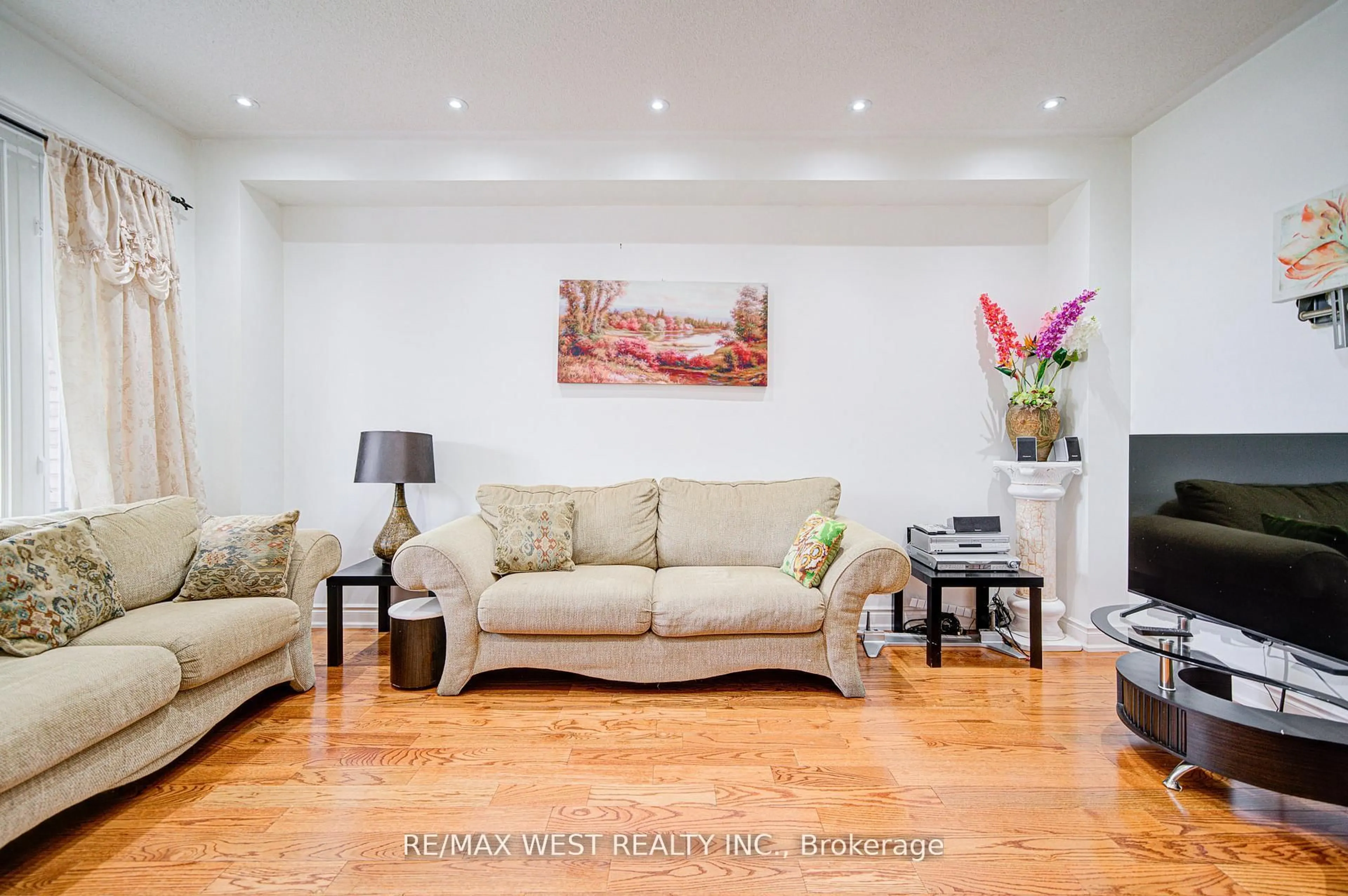 Living room with furniture, wood/laminate floor for 12 Eaglefield Gate, Brampton Ontario L7A 3S2