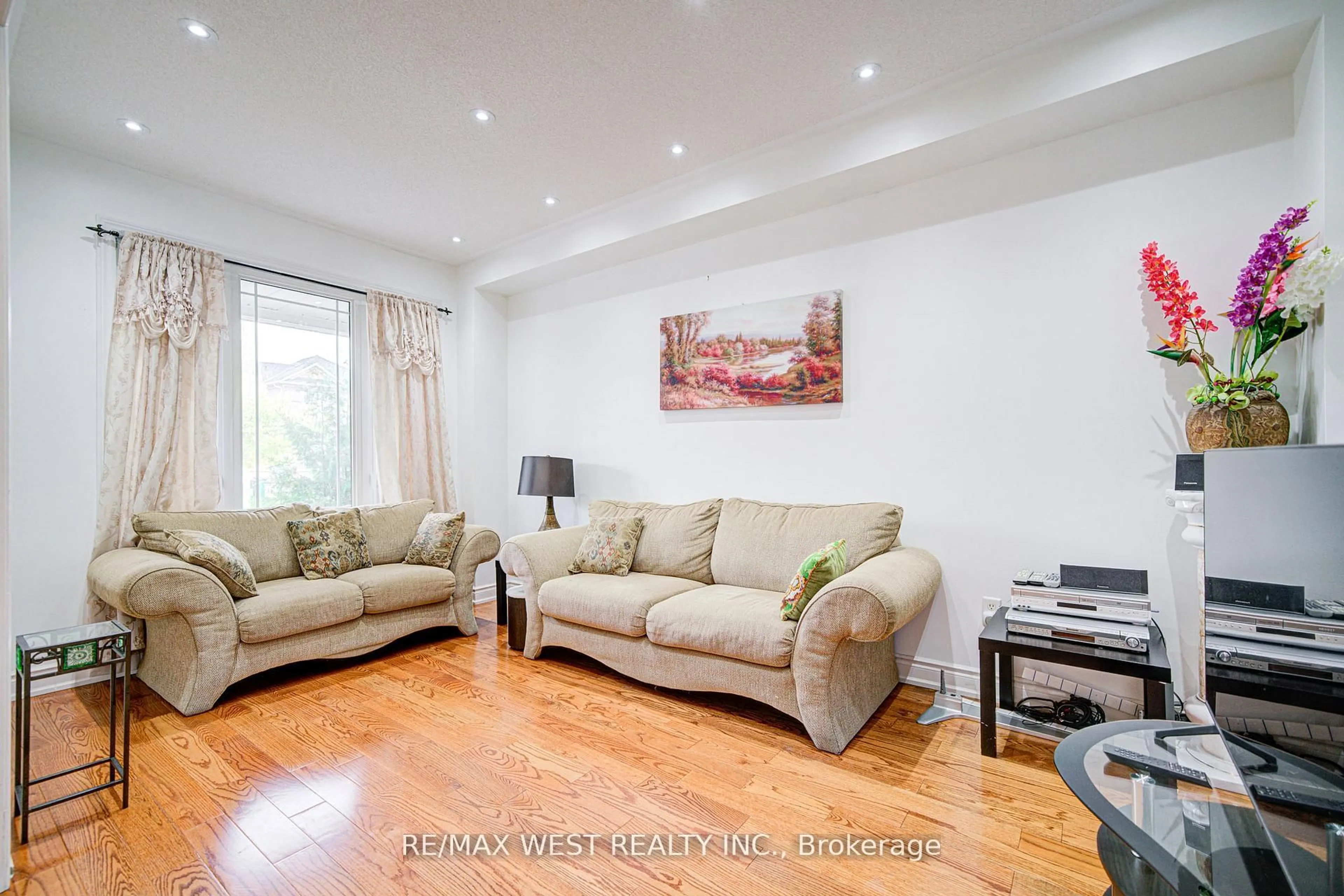 Living room with furniture, wood/laminate floor for 12 Eaglefield Gate, Brampton Ontario L7A 3S2