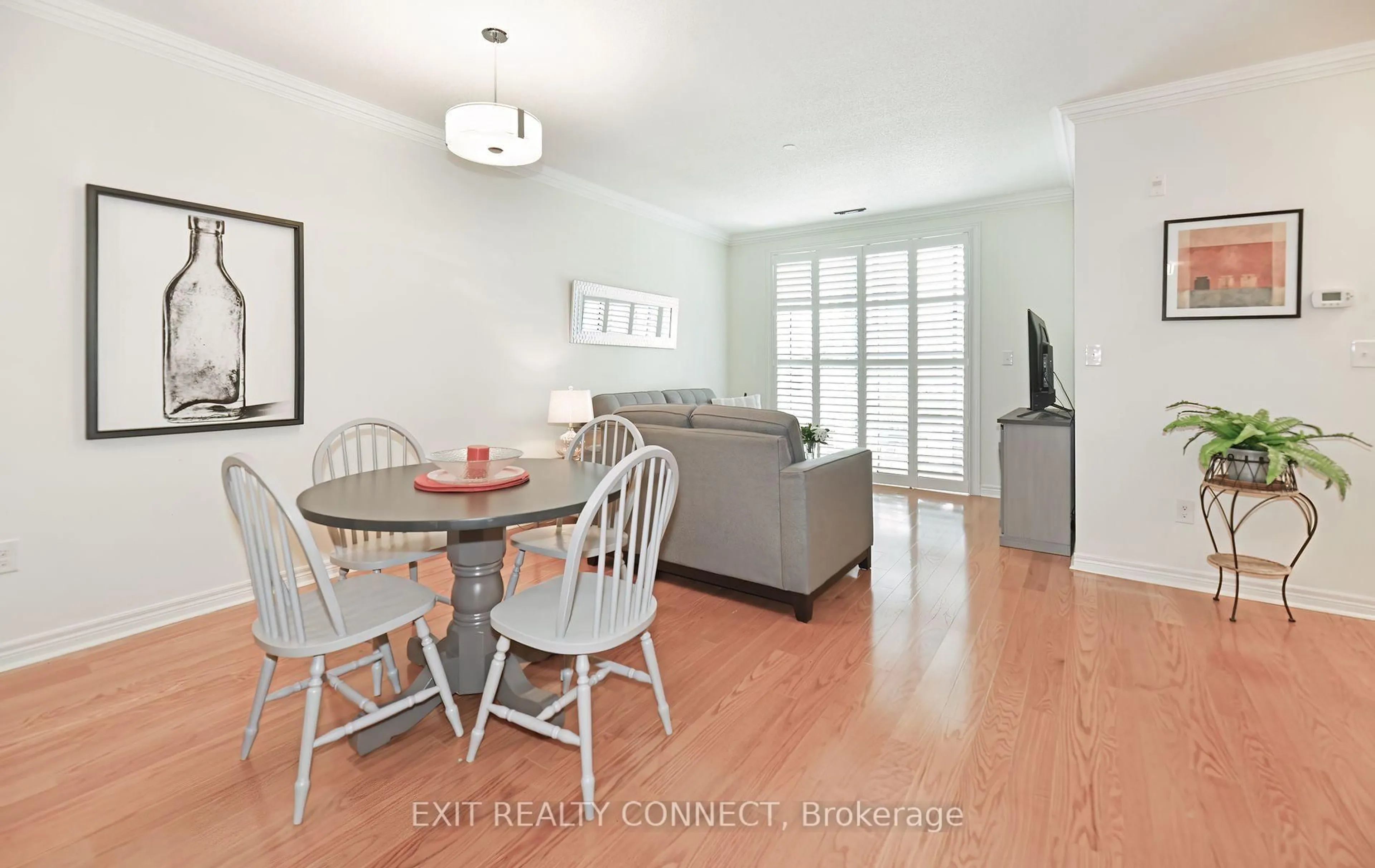 Living room with furniture, wood/laminate floor for 383 Main St #112, Milton Ontario L9T 8K8