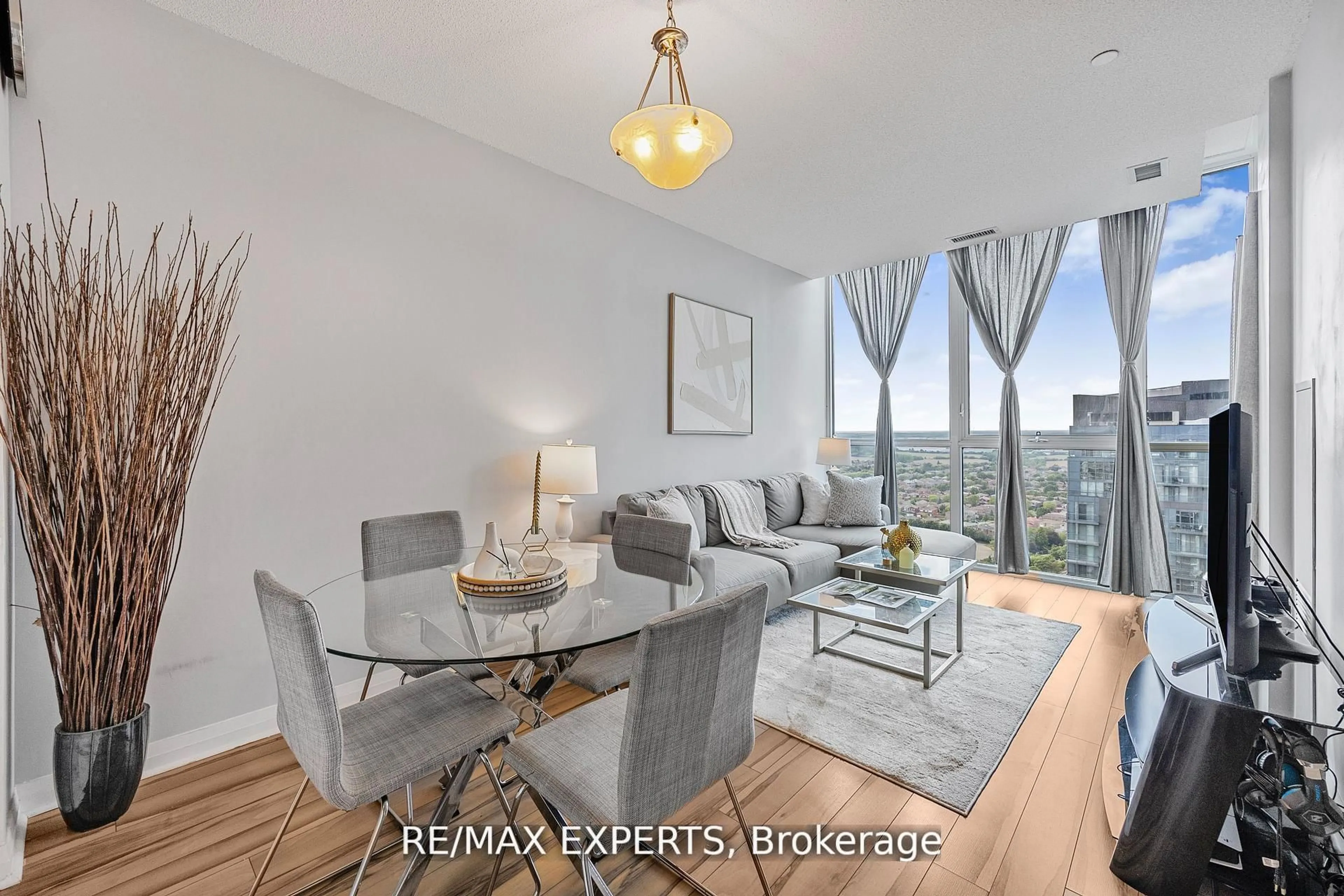 Living room with furniture, wood/laminate floor for 75 Eglinton Ave #2408, Mississauga Ontario L5R 0E5