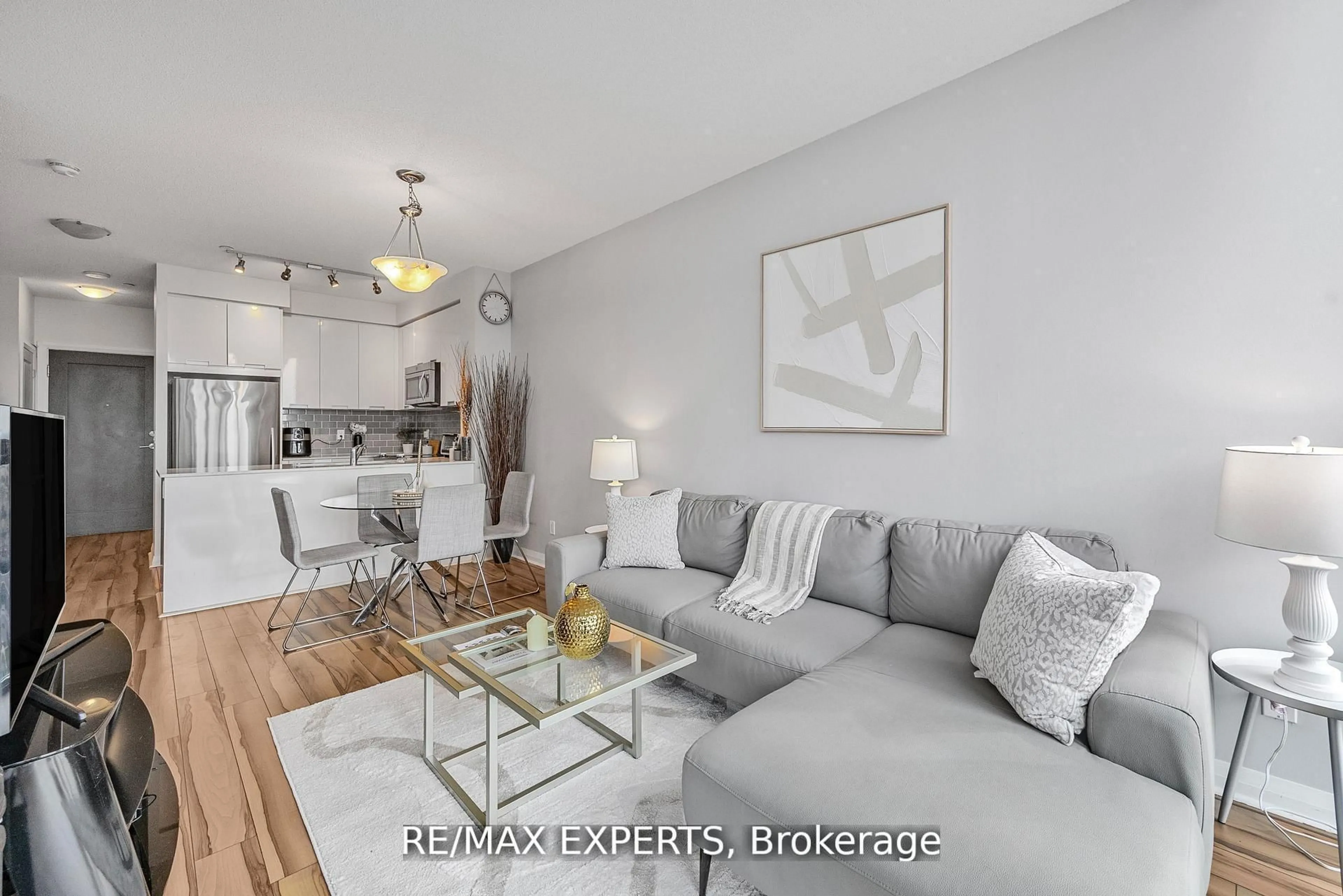 Living room with furniture, wood/laminate floor for 75 Eglinton Ave #2408, Mississauga Ontario L5R 0E5