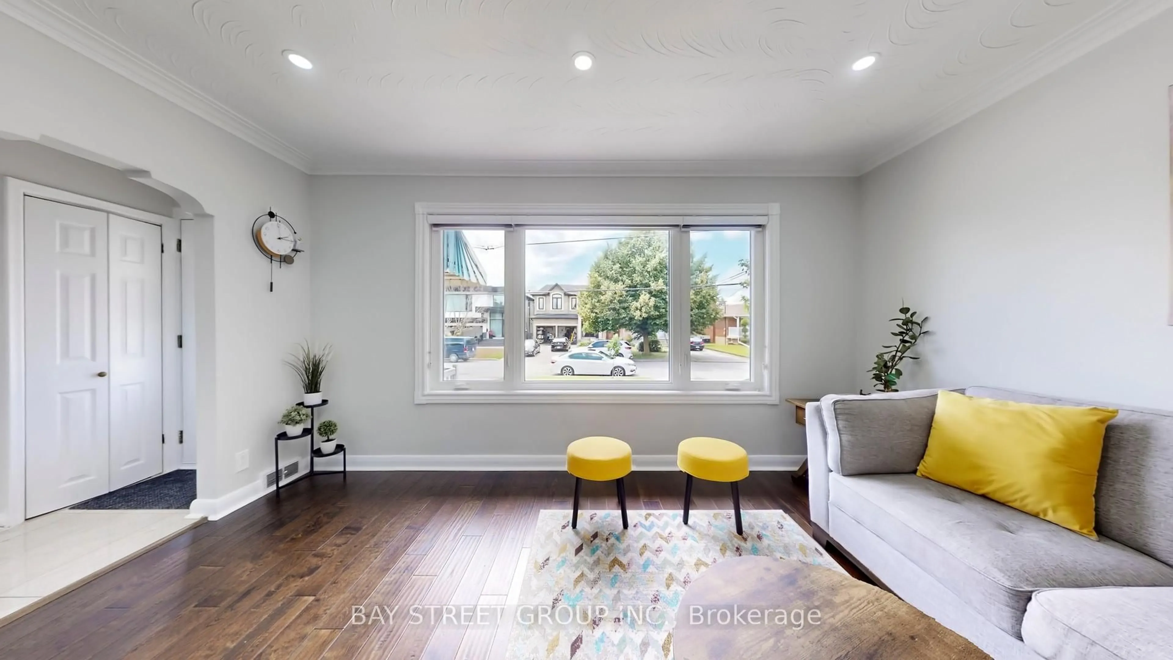 Living room with furniture, wood/laminate floor for 15 Macleod St, Toronto Ontario M6L 2M7