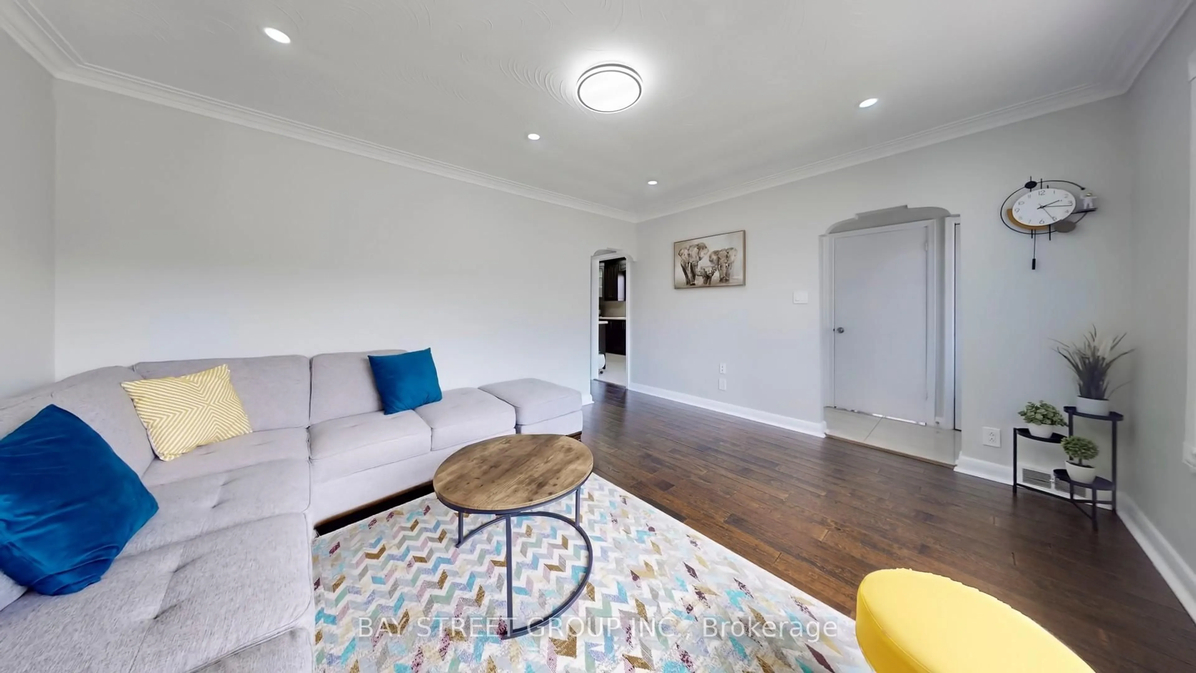 Living room with furniture, wood/laminate floor for 15 Macleod St, Toronto Ontario M6L 2M7