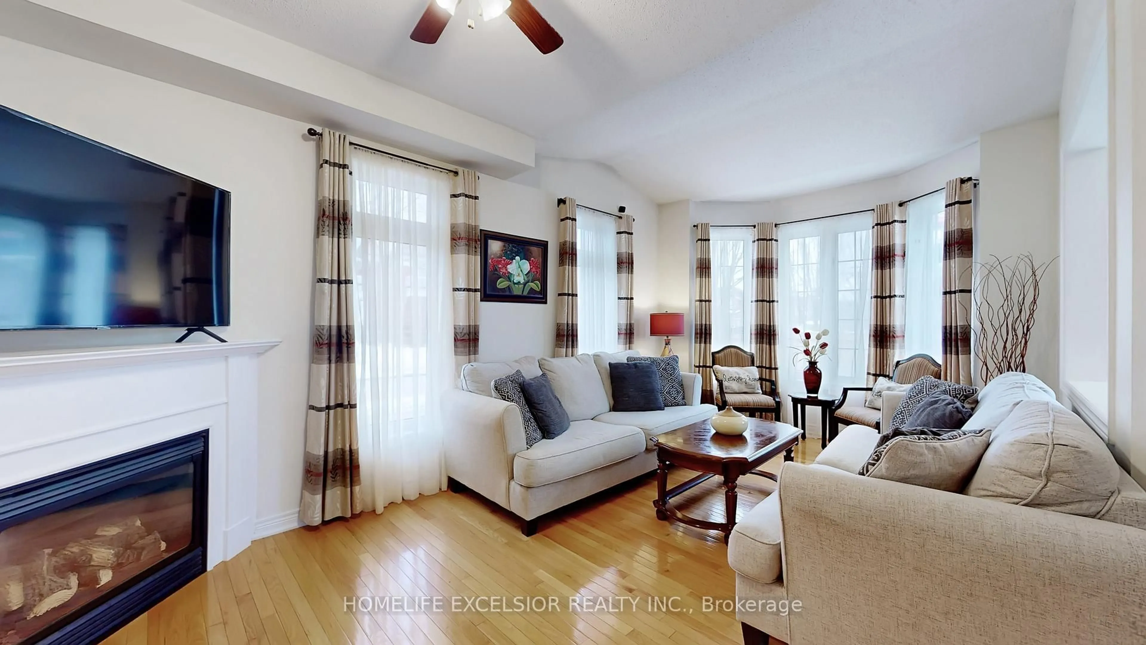 Living room with furniture, wood/laminate floor for 2 Wellsprings Dr, Brampton Ontario L6V 4S5