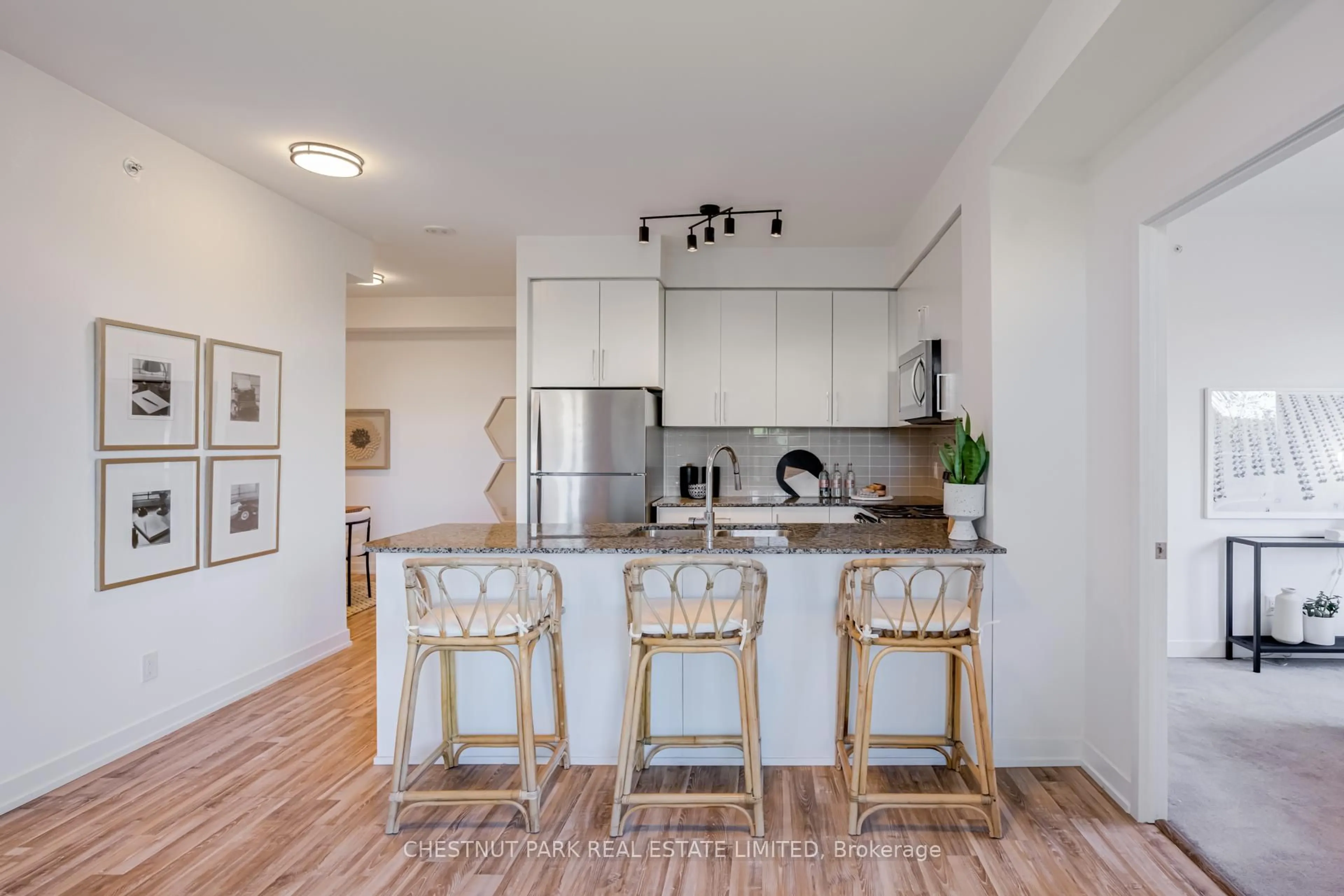 Open concept kitchen, wood/laminate floor for 840 Queens Plate Dr #205, Toronto Ontario M9W 0E7