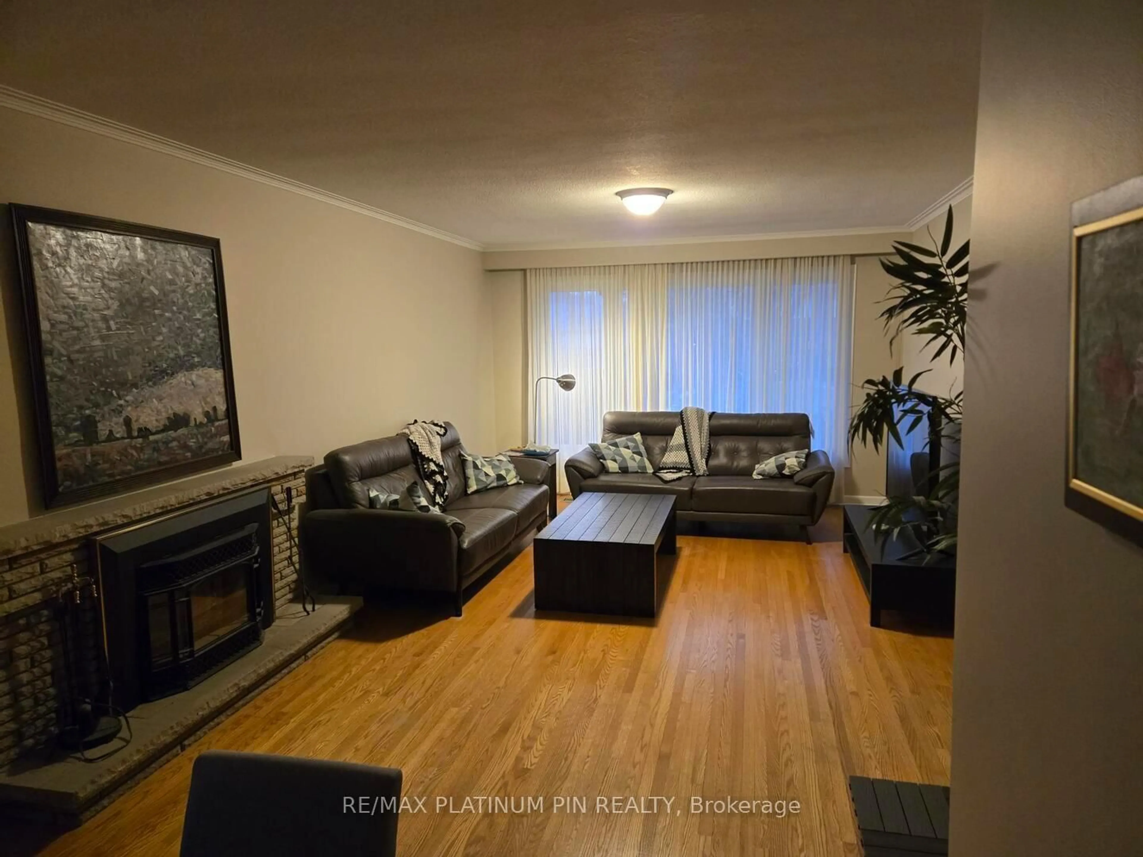 Living room with furniture, wood/laminate floor for 24 Hartsdale Dr, Toronto Ontario M9R 2S5