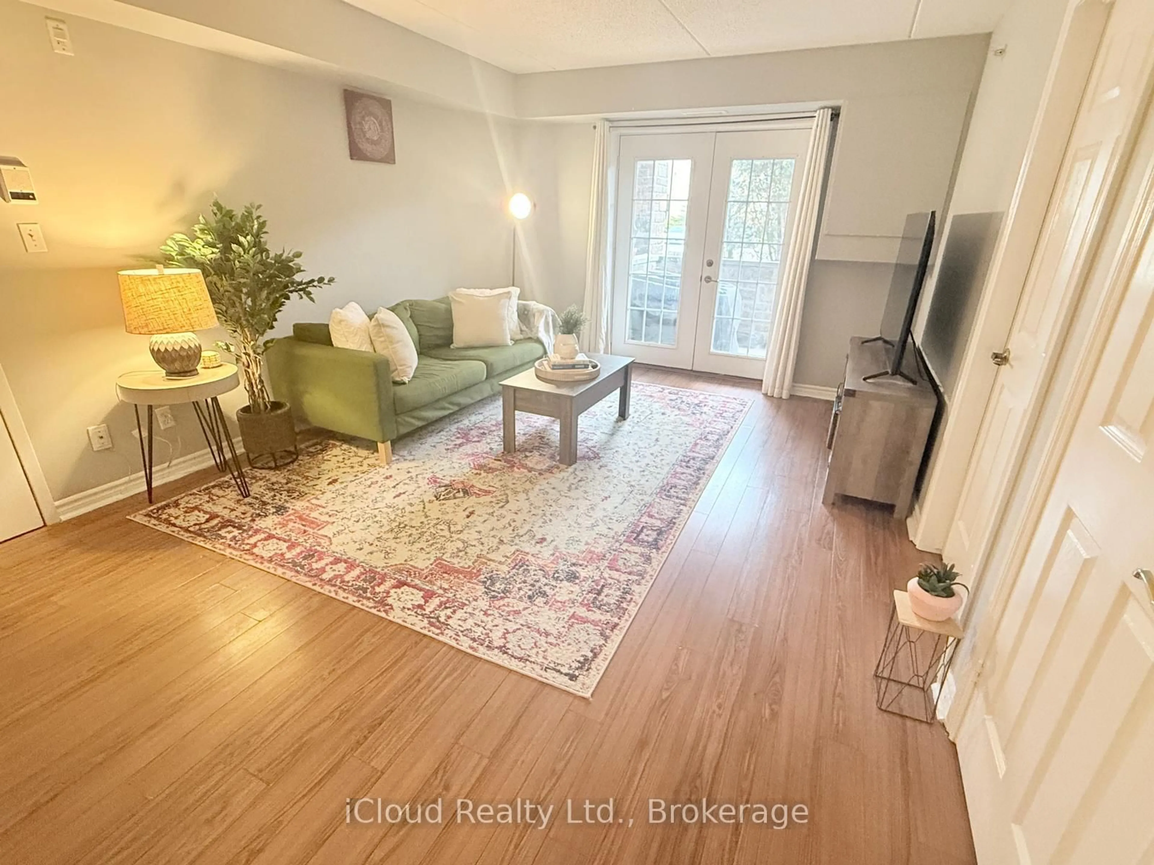 Living room with furniture, wood/laminate floor for 1470 Bishops Gate #104, Oakville Ontario L6M 4N2