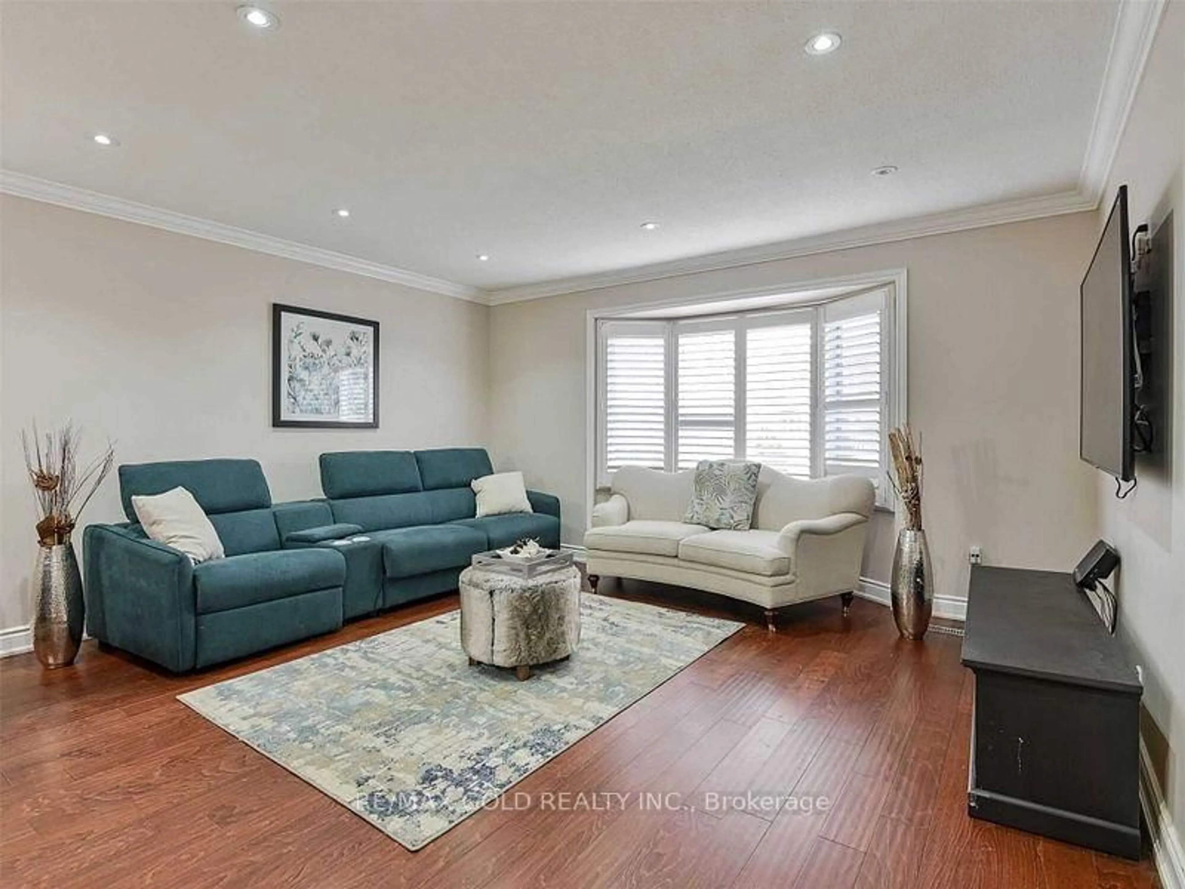 Living room with furniture, wood/laminate floor for 67 Archdekin Dr, Brampton Ontario L6V 1V1