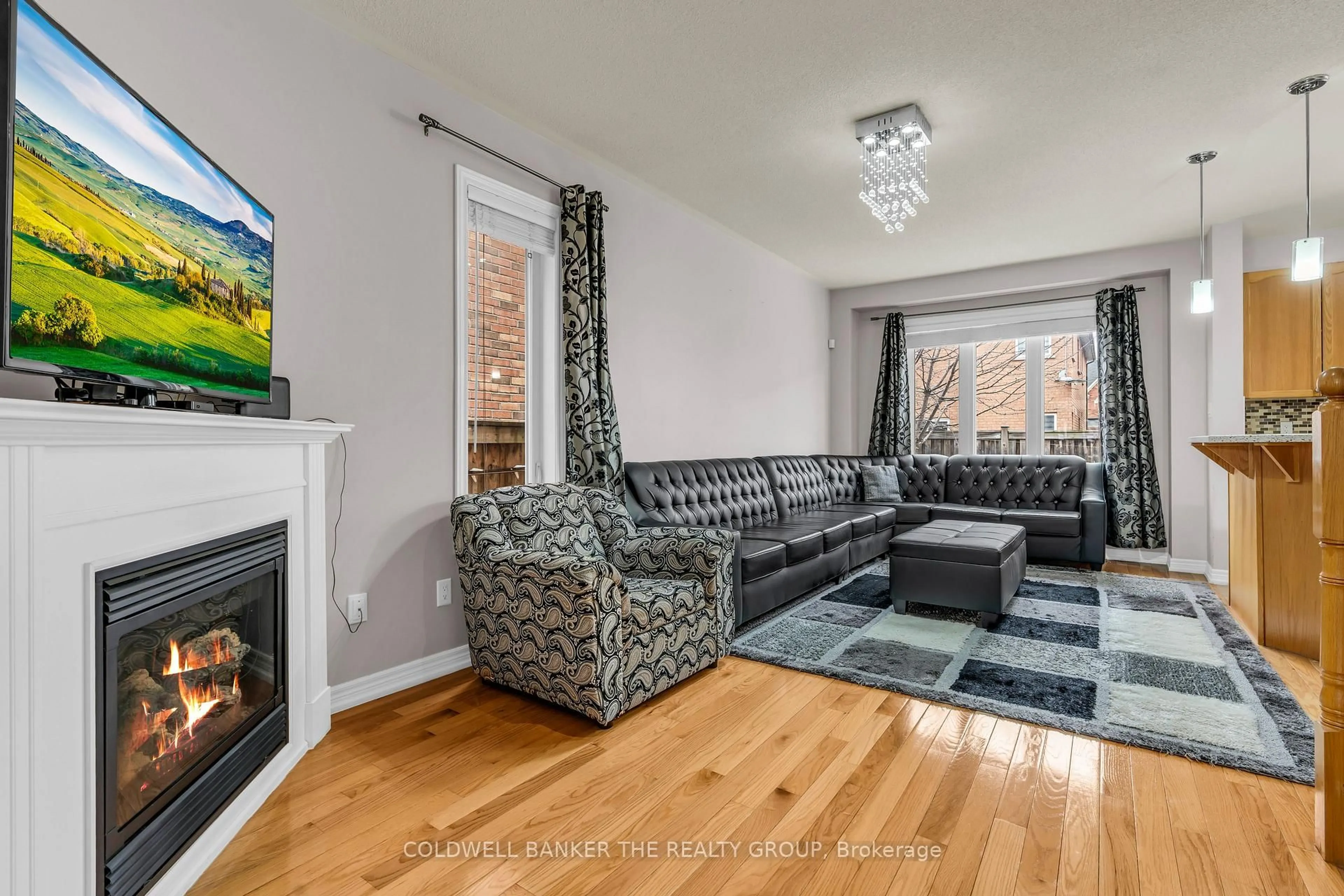 Living room with furniture, wood/laminate floor for 5 Amaryllis Dr, Brampton Ontario L7A 0M4