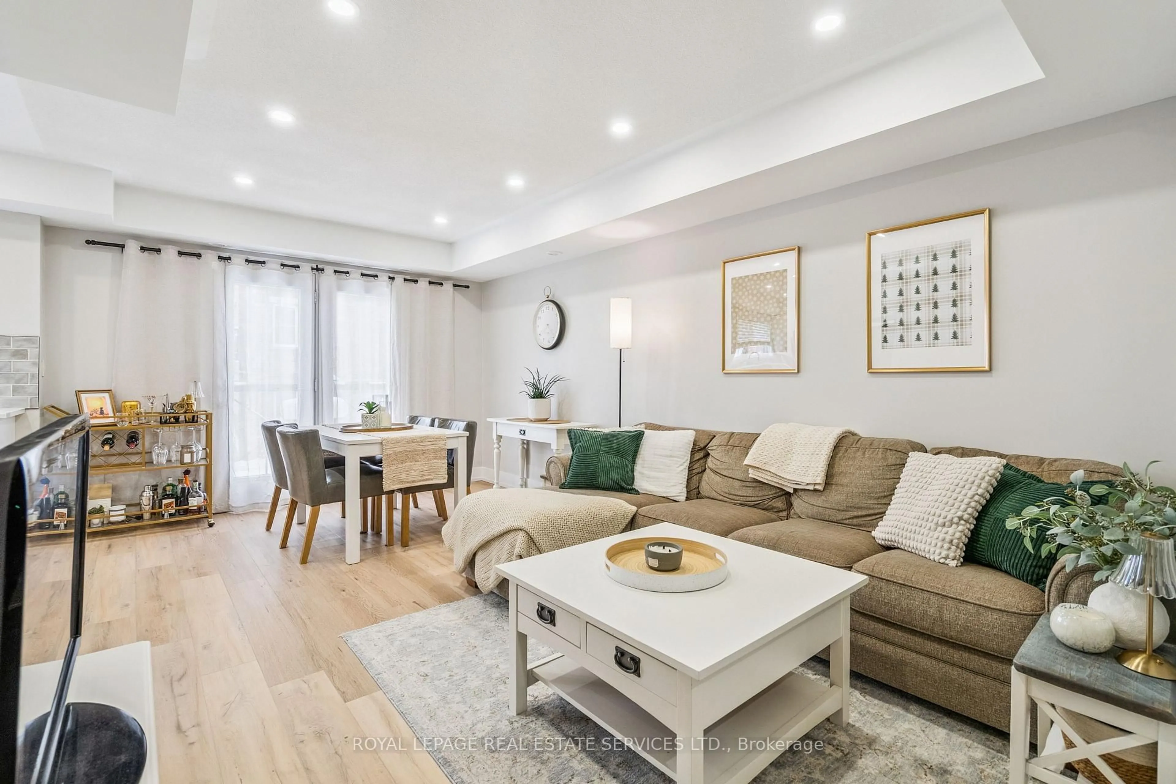 Living room with furniture, wood/laminate floor for 2444 Post Rd #9, Oakville Ontario L6H 0J2