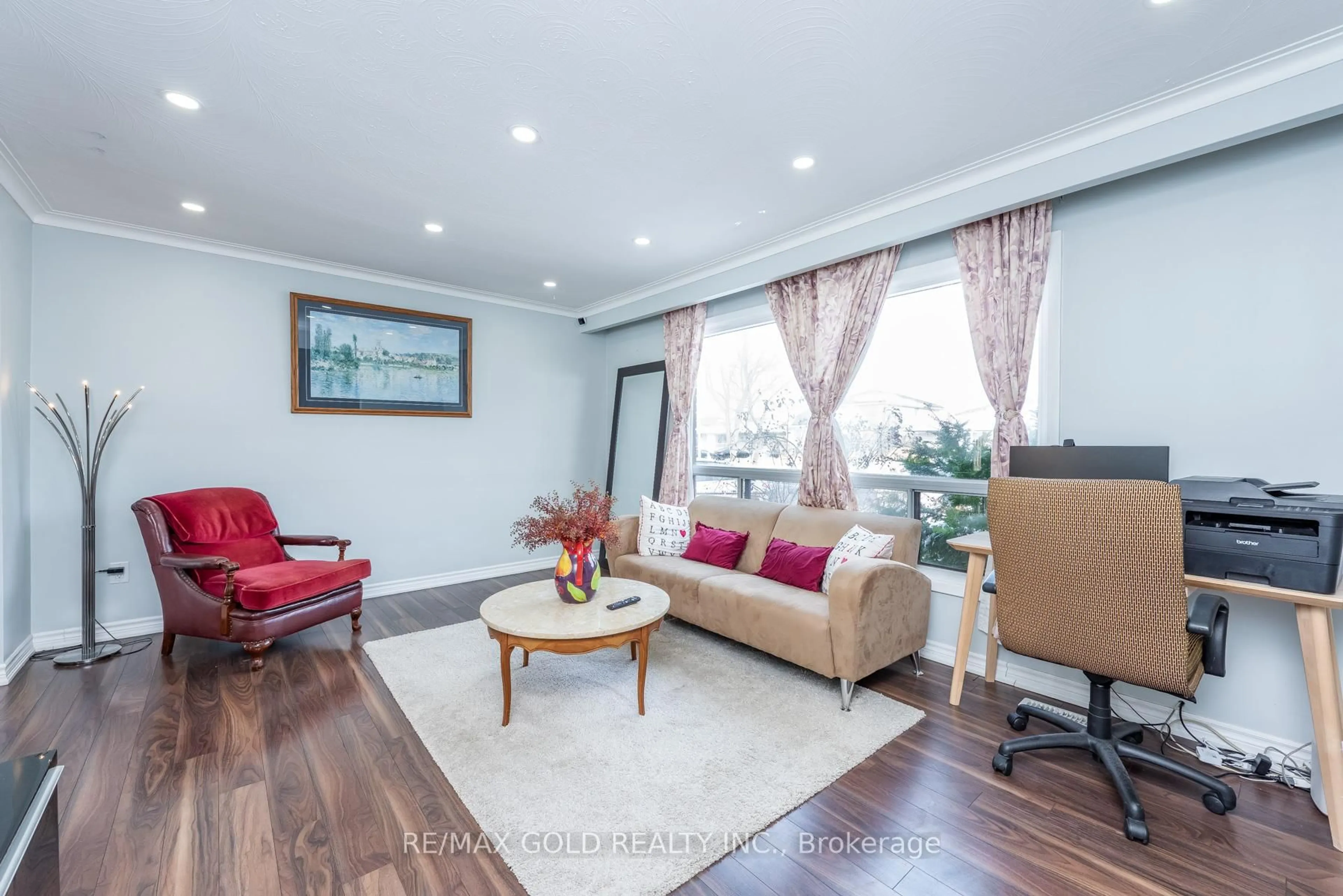 Living room with furniture, wood/laminate floor for 7258 Vernor Dr, Mississauga Ontario L4T 2P4