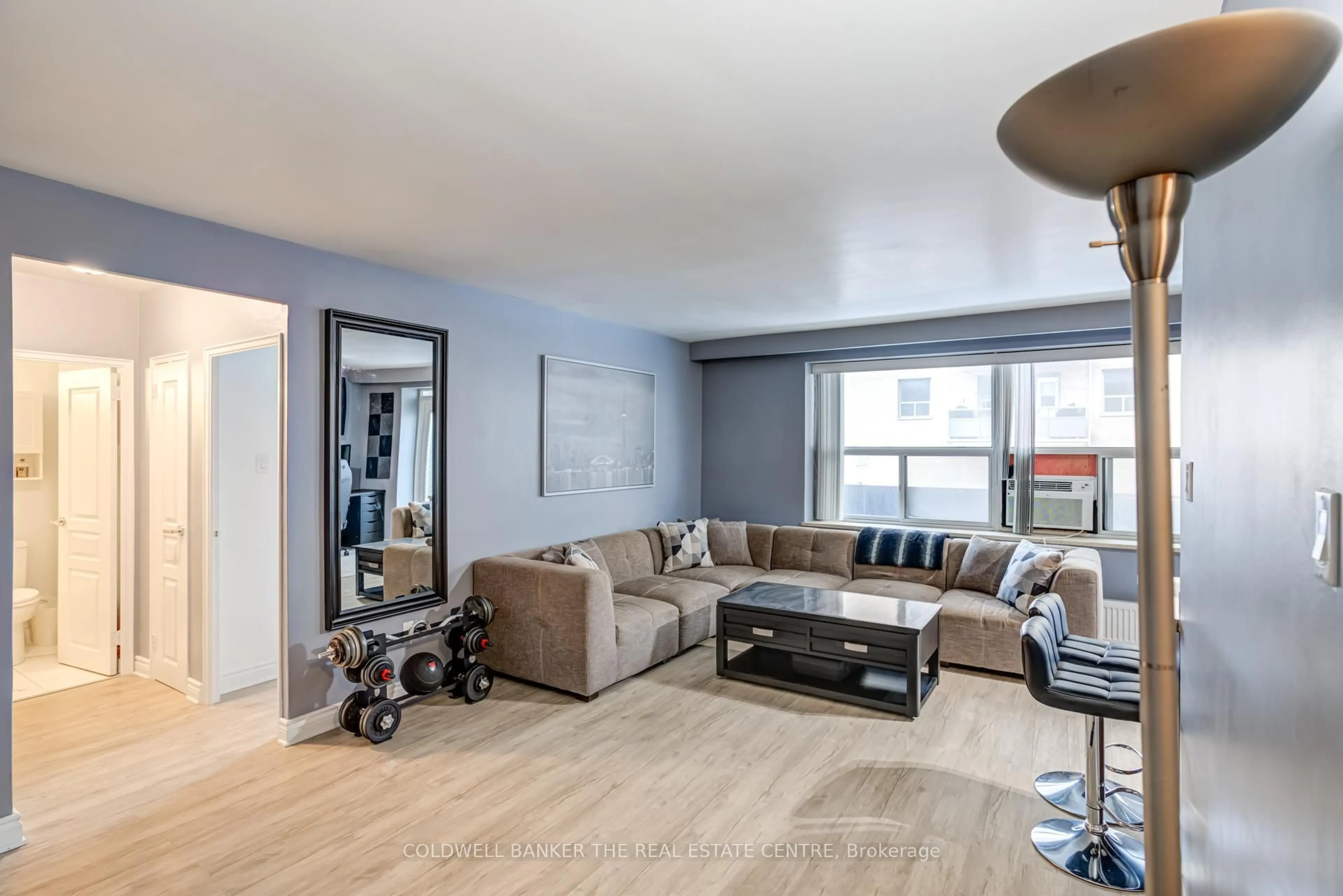 Living room with furniture, wood/laminate floor for 50 Gulliver Rd #208, Toronto Ontario M6M 2N2