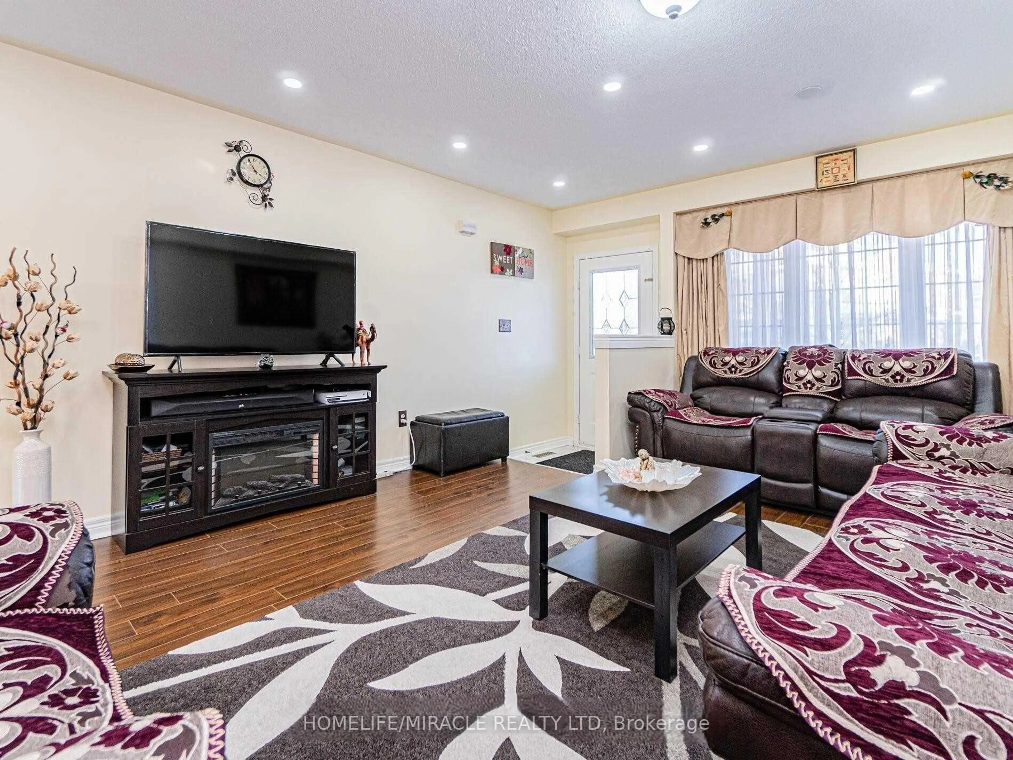 Living room with furniture, wood/laminate floor for 76 Starhill Cres, Brampton Ontario L6R 2W1