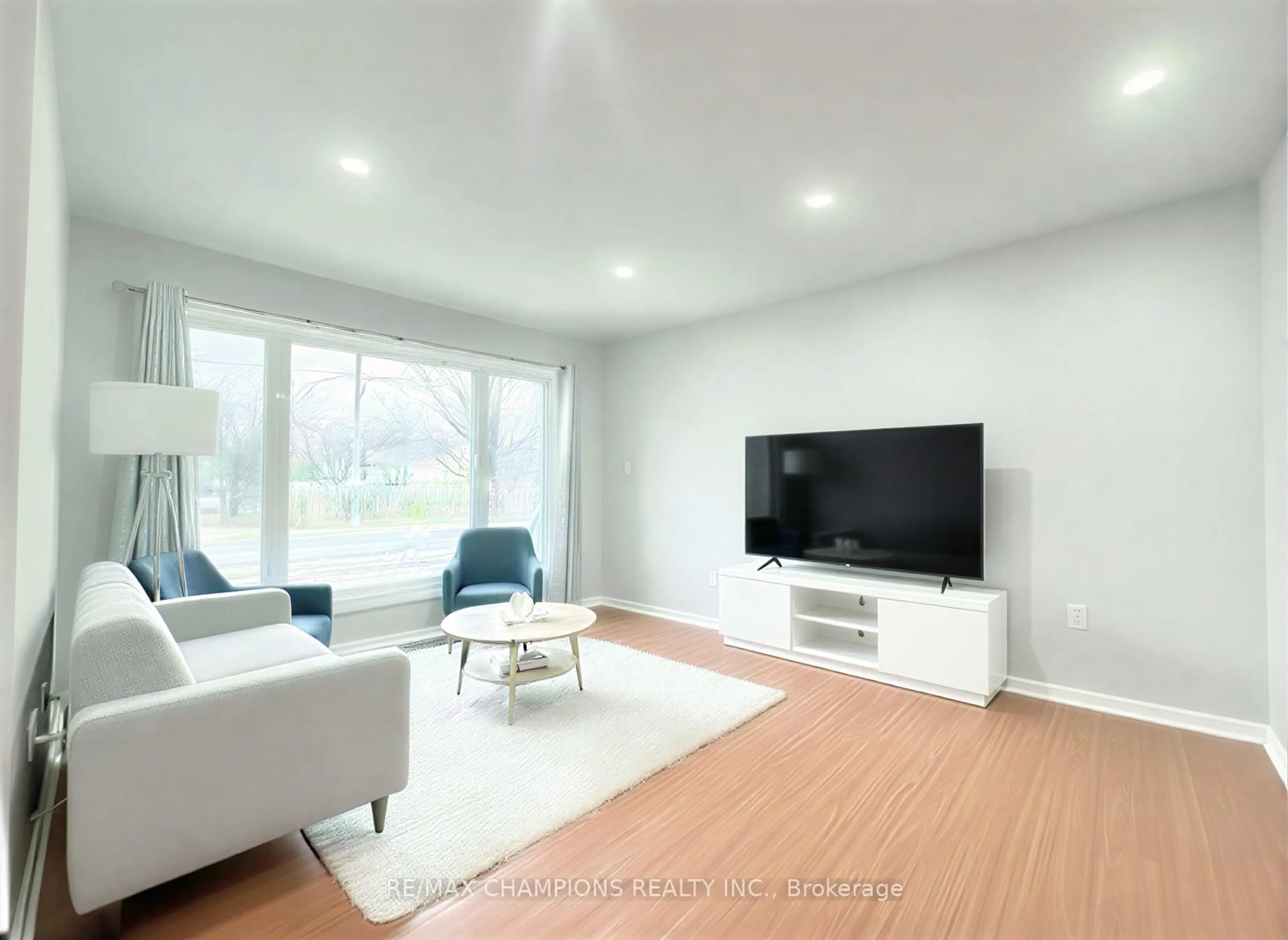 Living room with furniture, wood/laminate floor for 68 Nanwood Dr, Brampton Ontario L6W 1L9