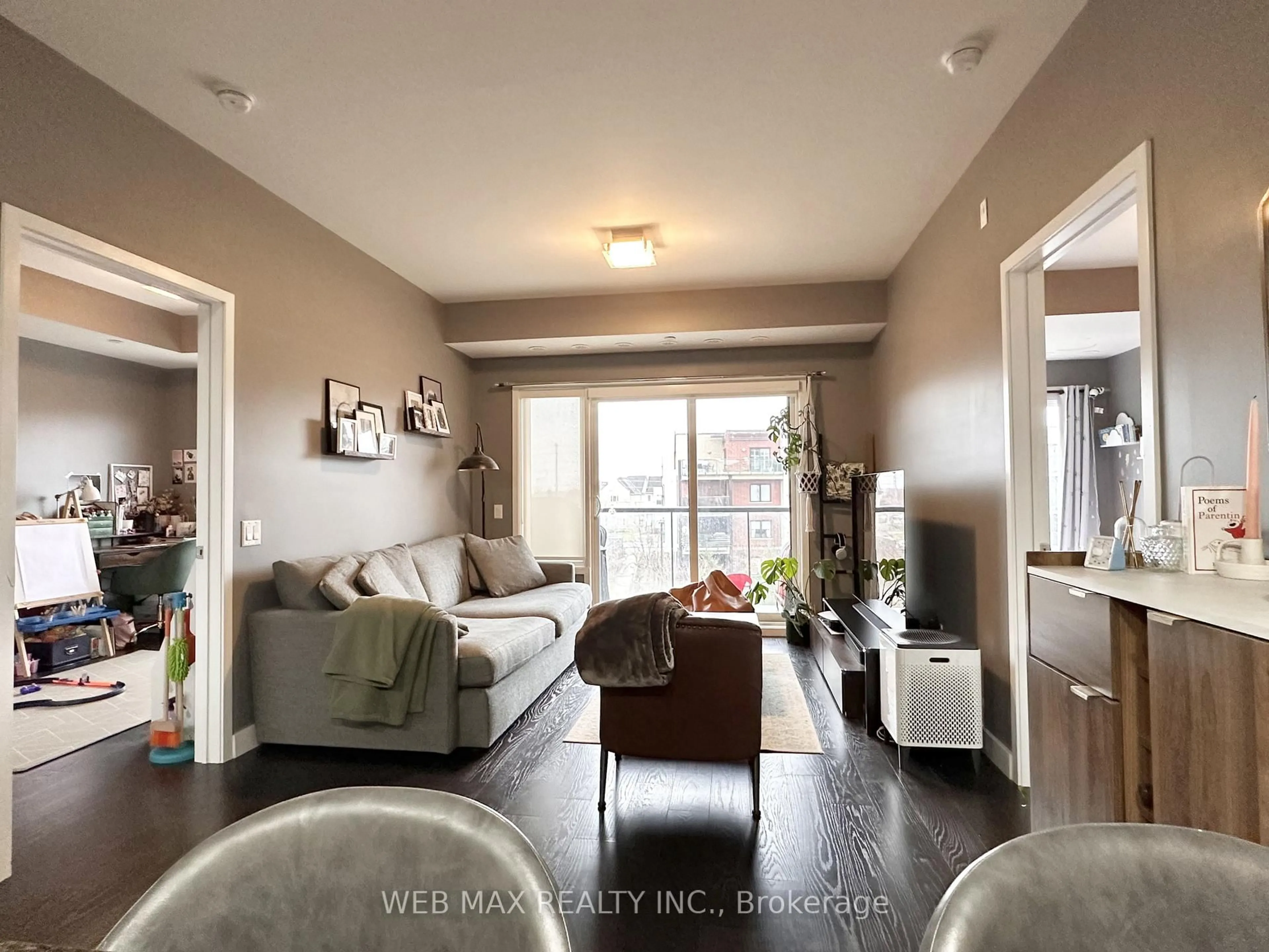 Living room with furniture, wood/laminate floor for 5035 Harvard Rd #314, Mississauga Ontario L5M 0W7