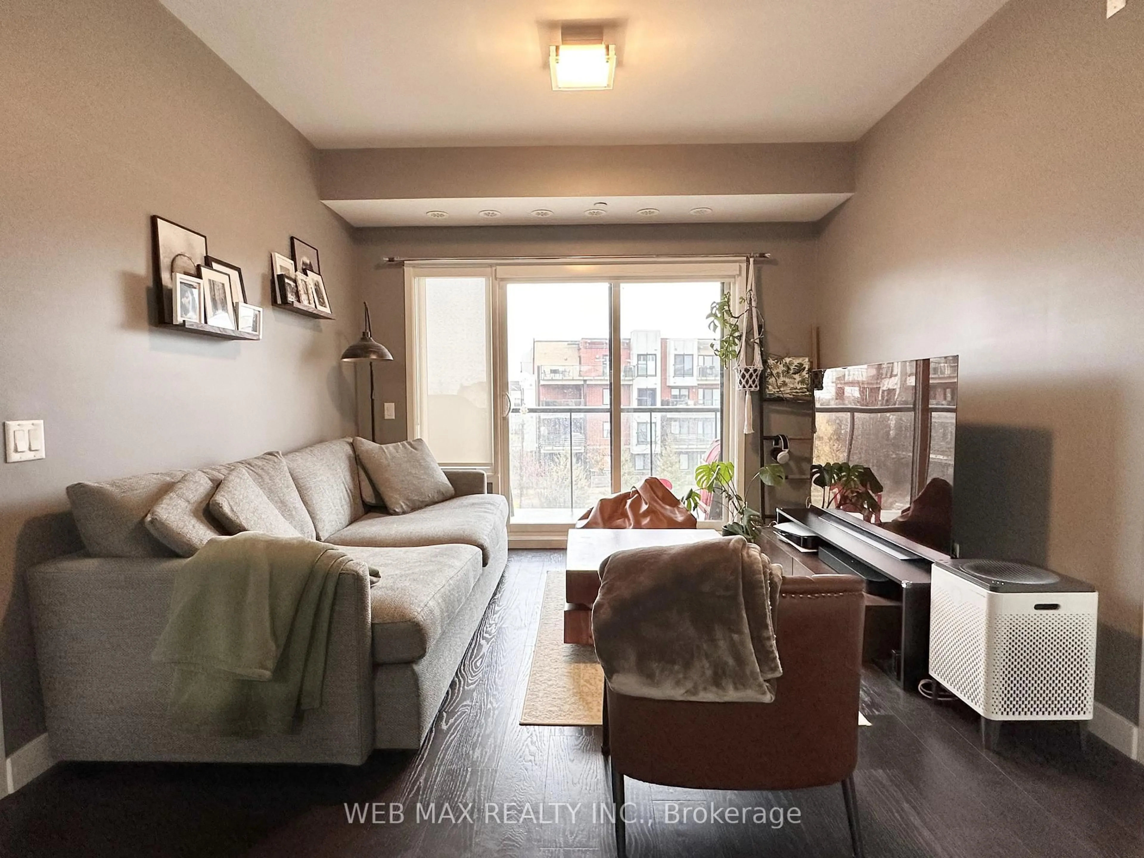 Living room with furniture, wood/laminate floor for 5035 Harvard Rd #314, Mississauga Ontario L5M 0W7