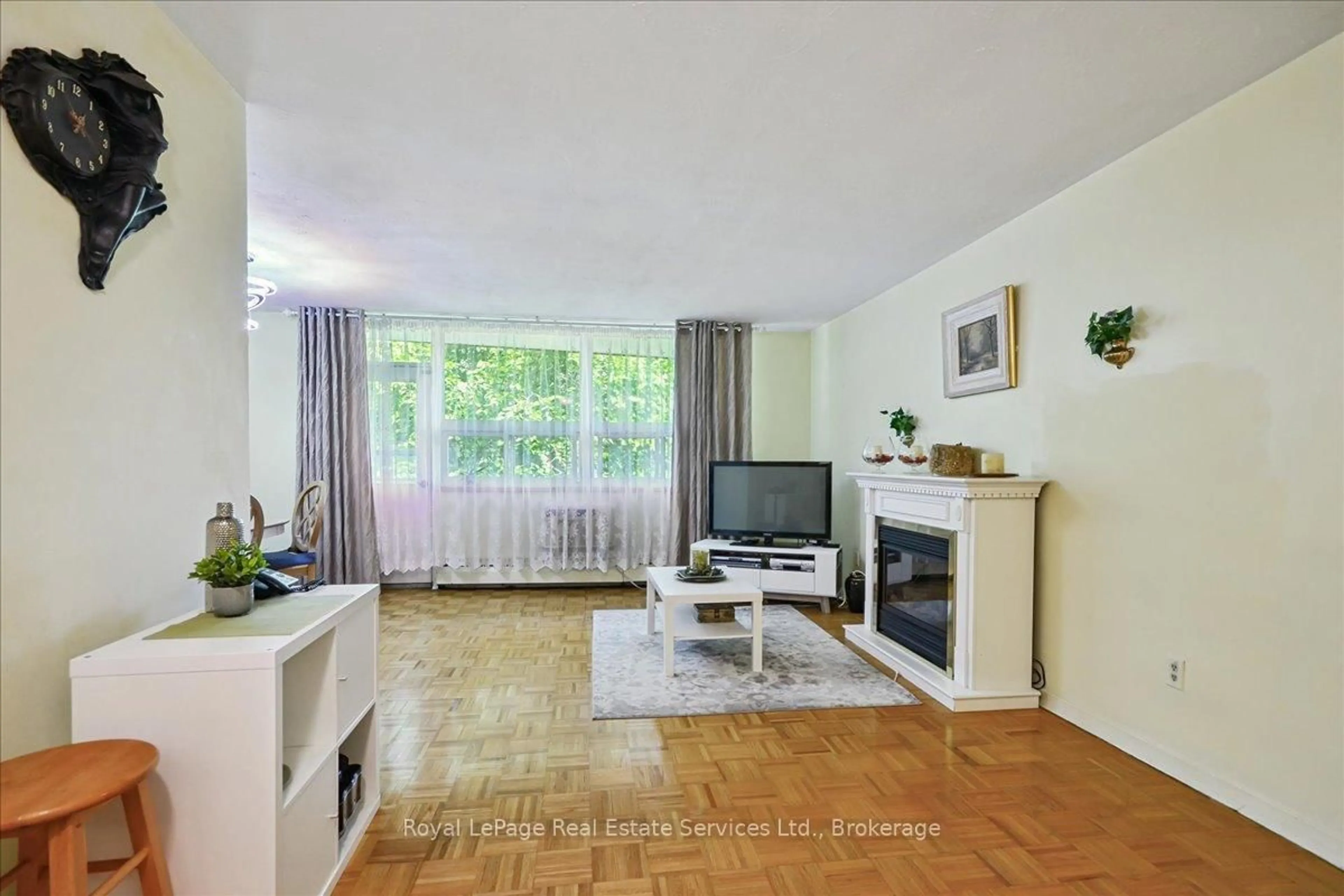 Living room with furniture, wood/laminate floor for 100 Coe Hill Dr #203, Toronto Ontario M6S 3E1