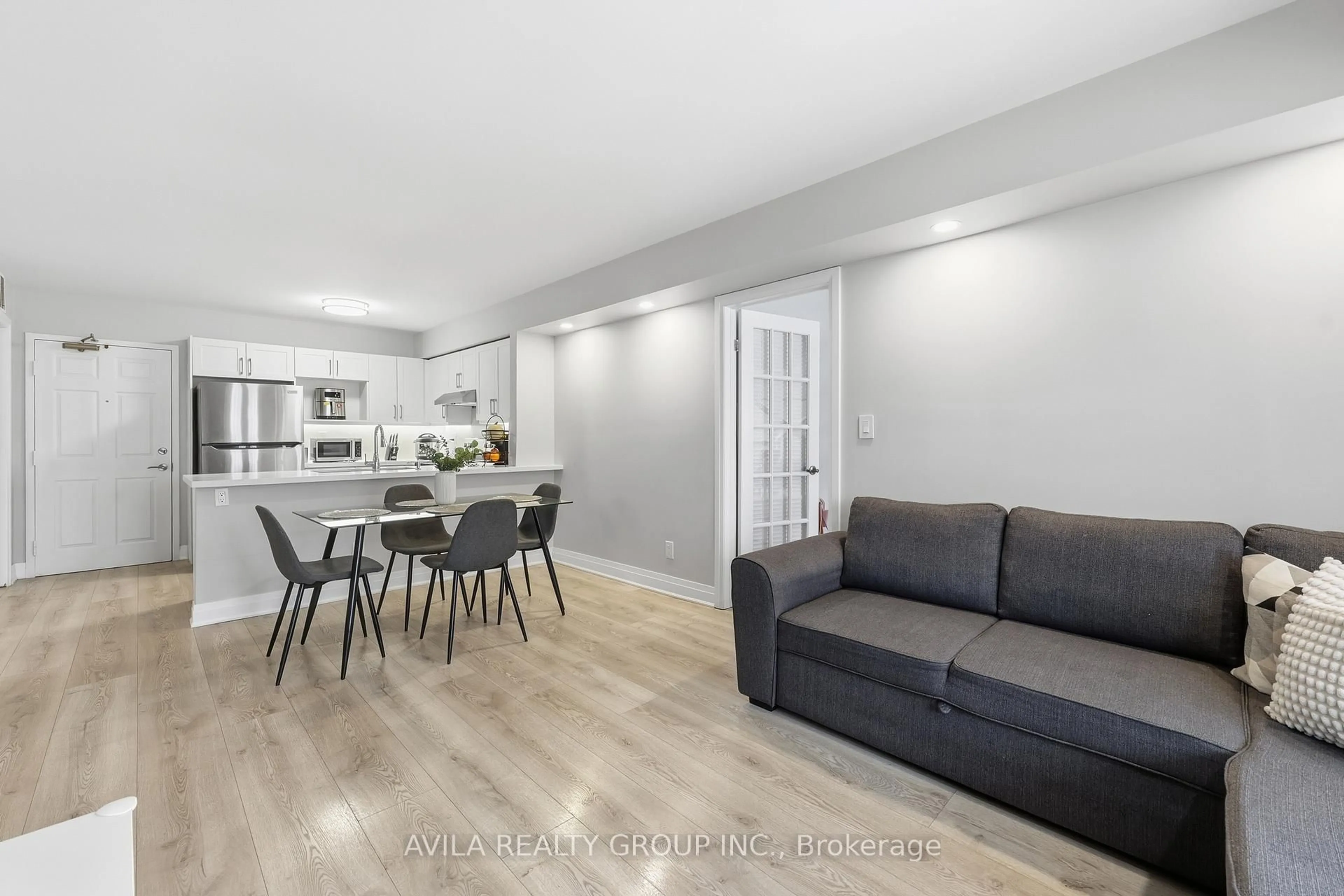 Living room with furniture, wood/laminate floor for 1460 Bishops Gate #203, Oakville Ontario L6M 4N5