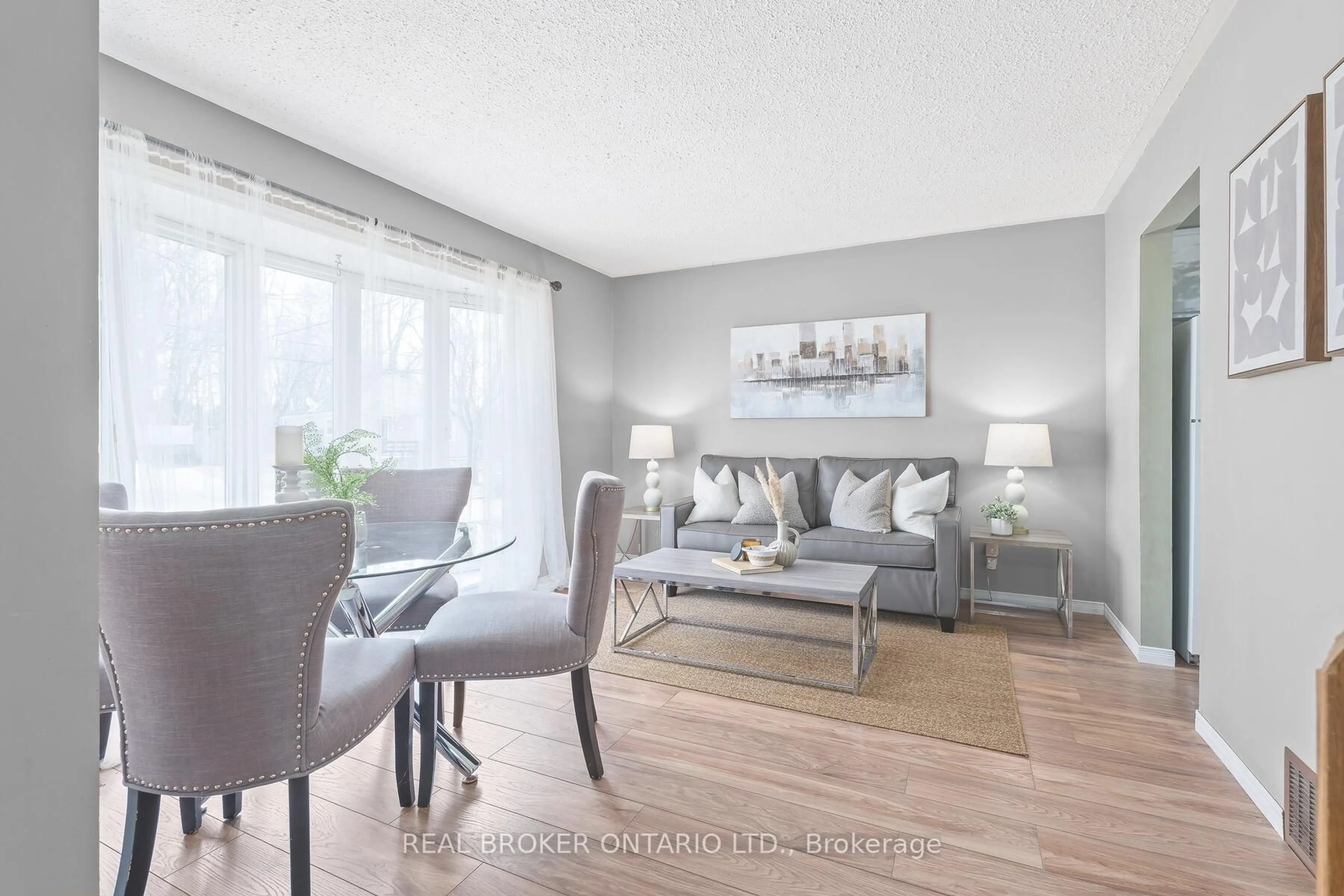 Living room with furniture, wood/laminate floor for 19 Dayfoot Dr, Halton Hills Ontario L7G 2K8