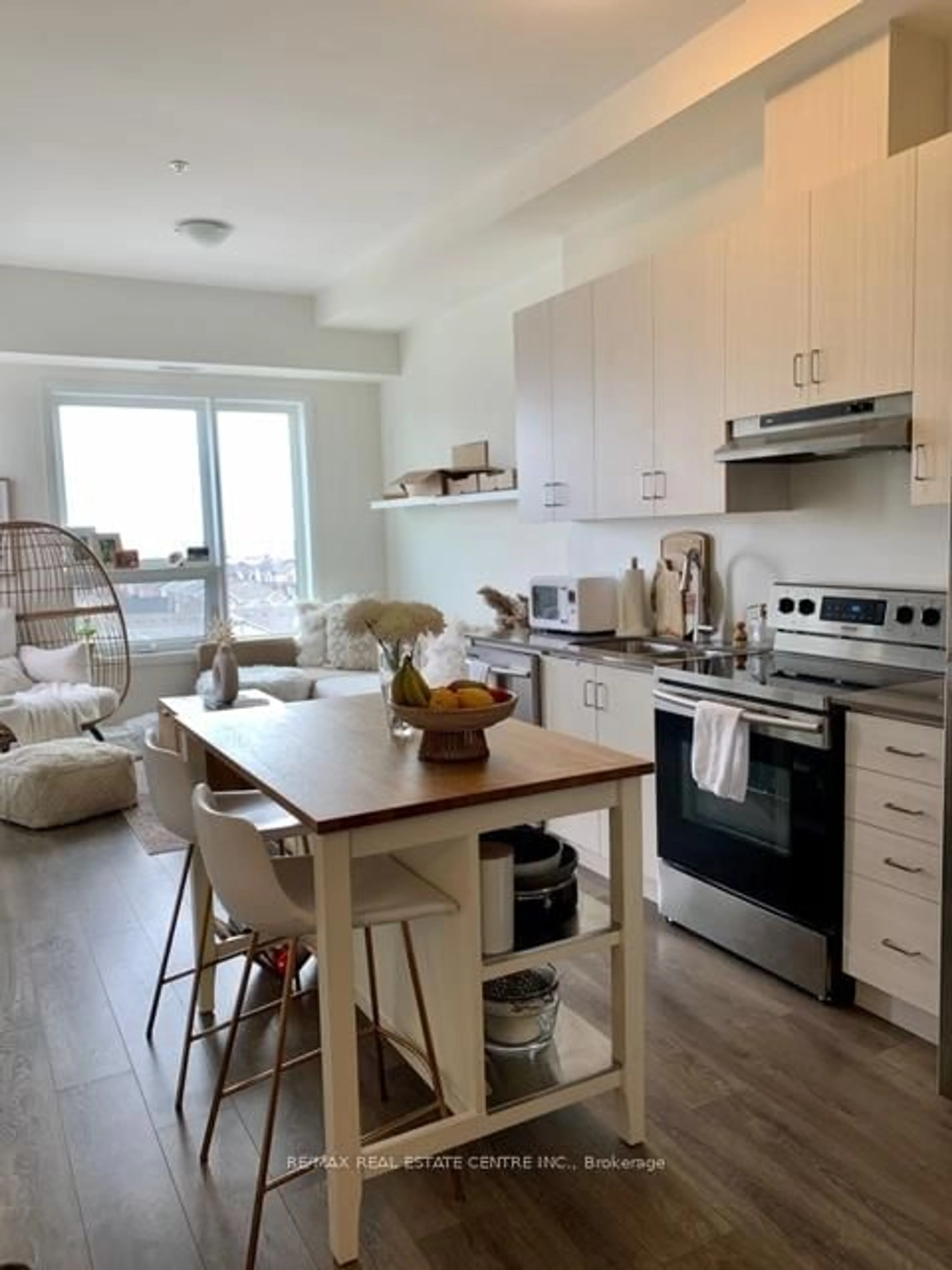 Open concept kitchen, wood/laminate floor for 1105 Leger Way #604, Milton Ontario L9E 1K7