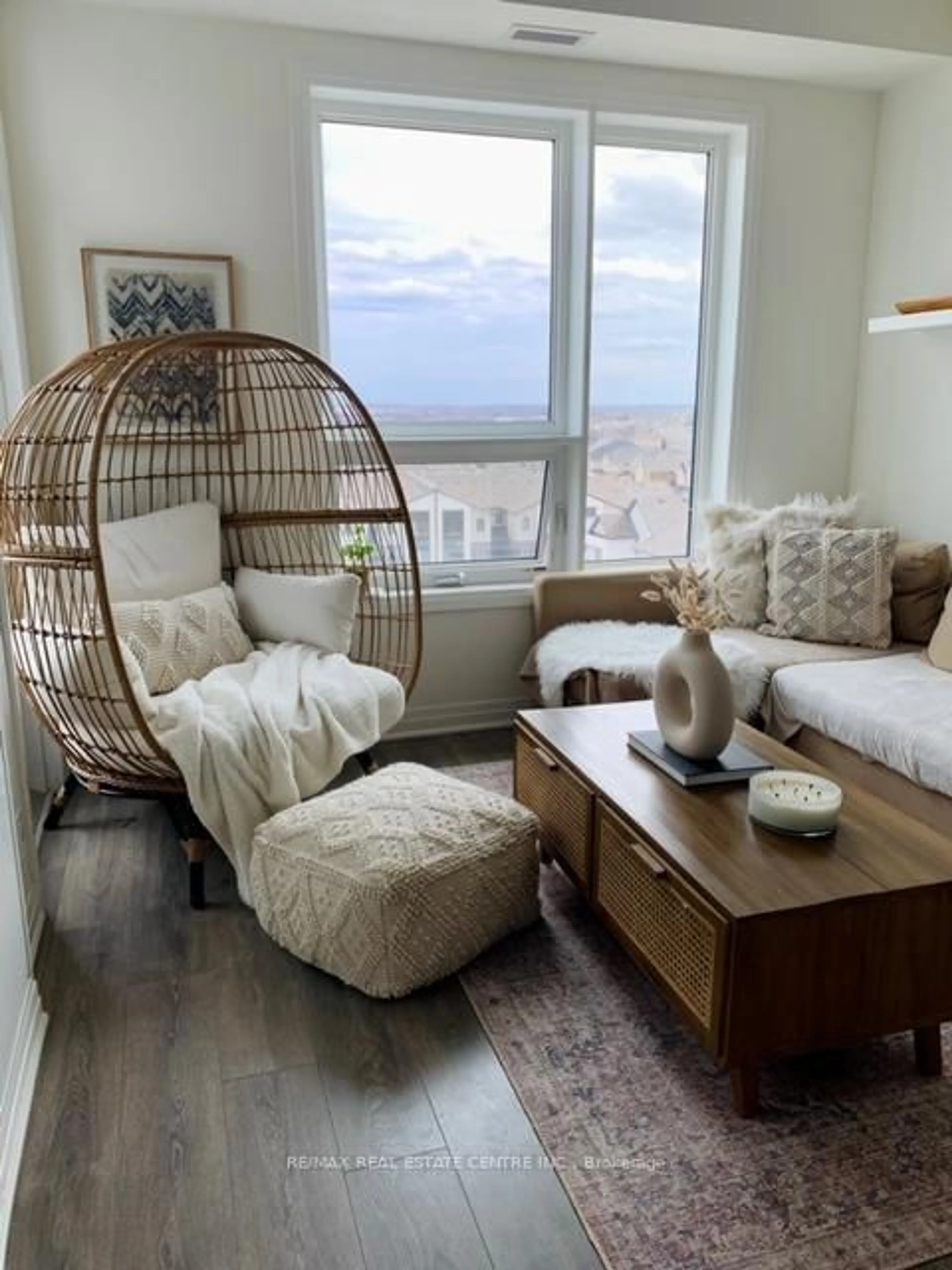 Living room with furniture, wood/laminate floor for 1105 Leger Way #604, Milton Ontario L9E 1K7