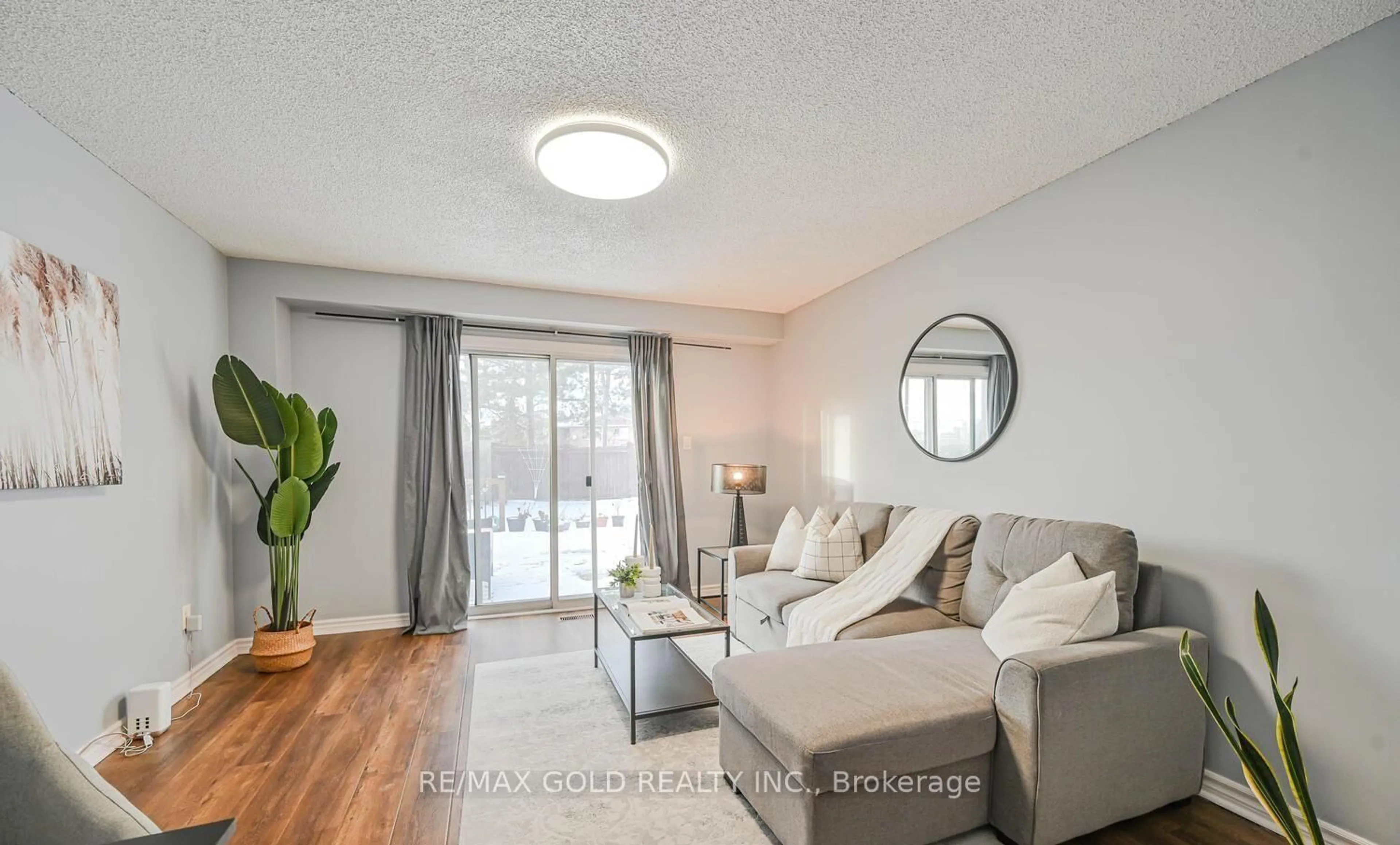 Living room with furniture, wood/laminate floor for 73 Chipmunk Cres, Brampton Ontario L6R 1B4