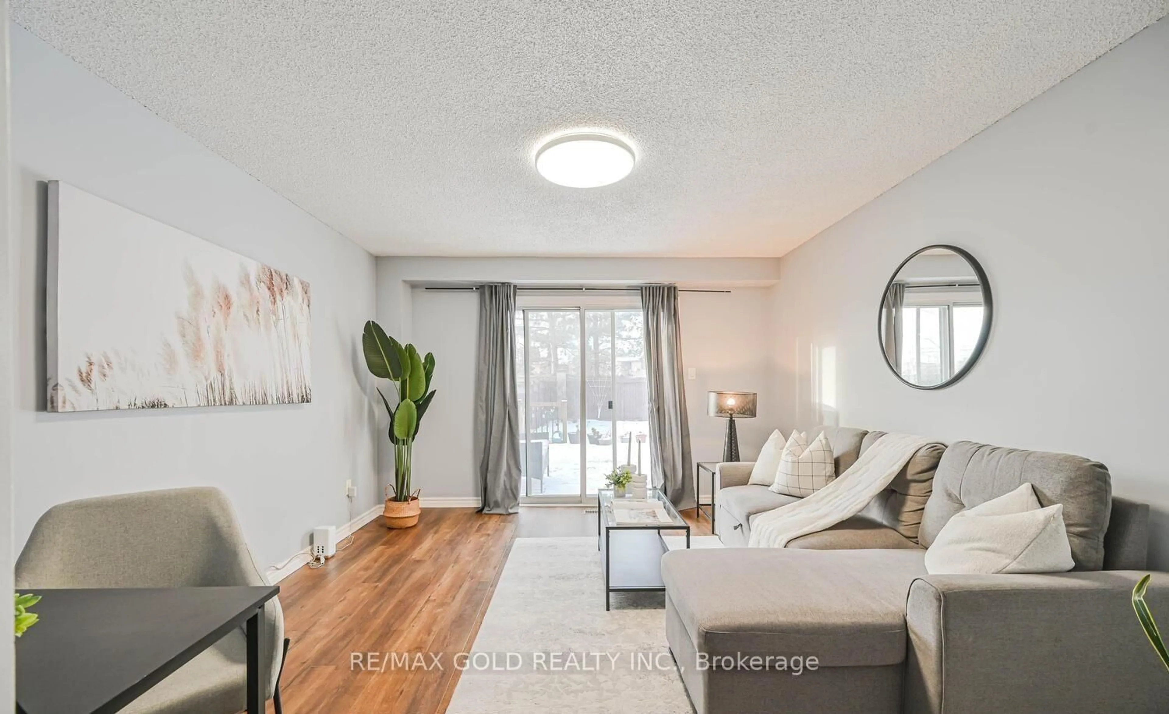 Living room with furniture, wood/laminate floor for 73 Chipmunk Cres, Brampton Ontario L6R 1B4