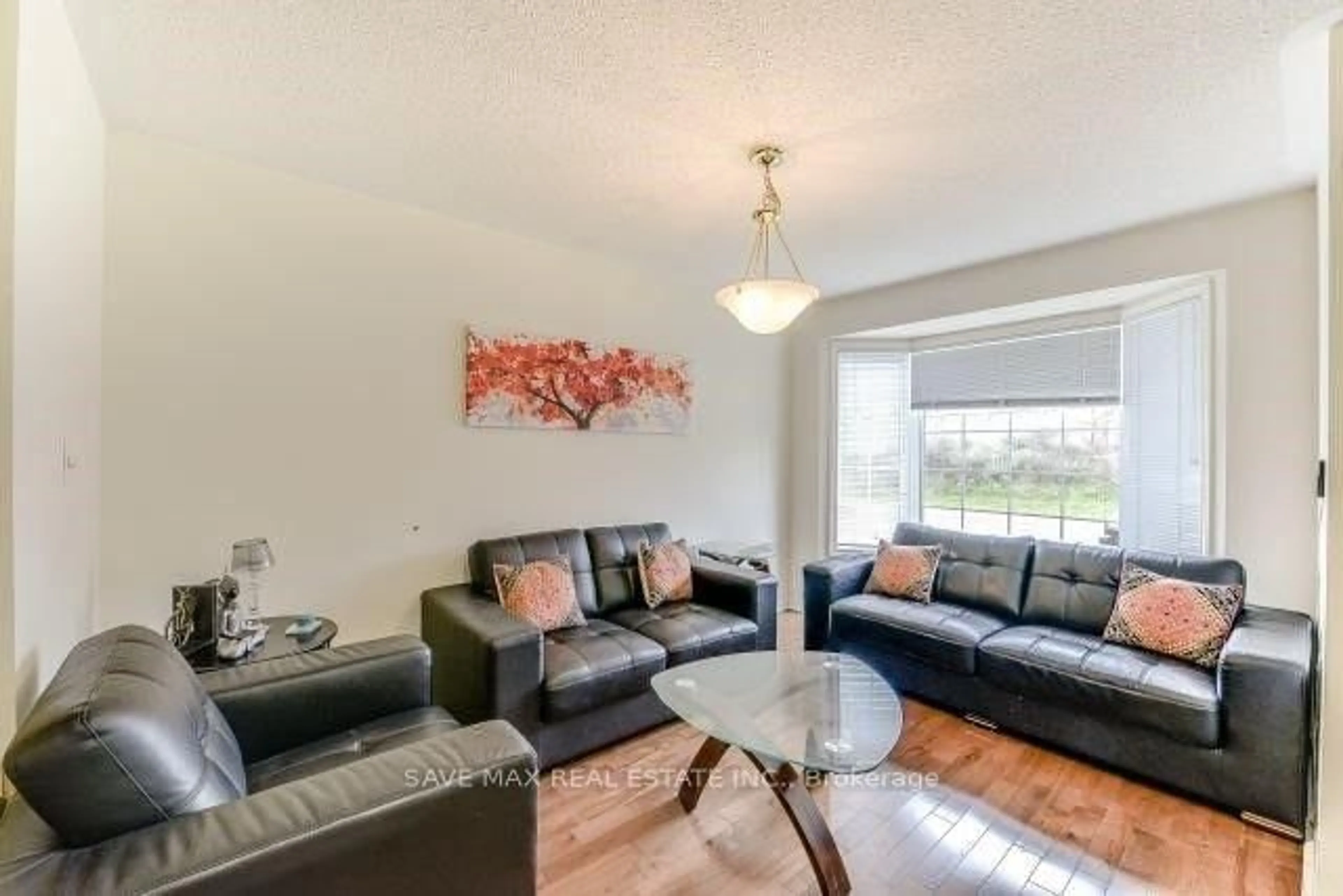 Living room with furniture, wood/laminate floor for 23 Owlridge Dr, Brampton Ontario L6X 0M3