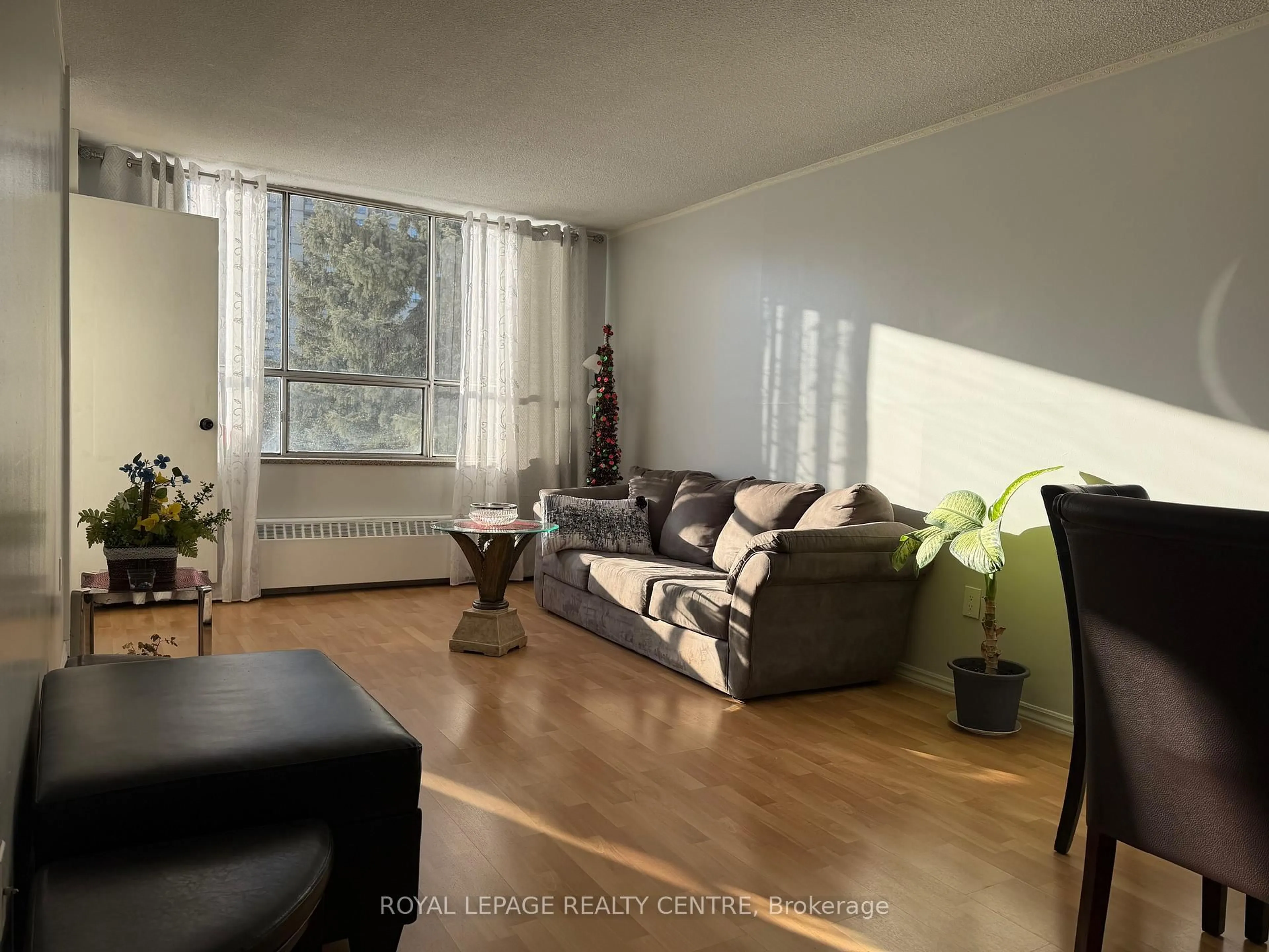 Living room with furniture, wood/laminate floor for 340 Dixon Rd #209, Toronto Ontario M9R 1T1