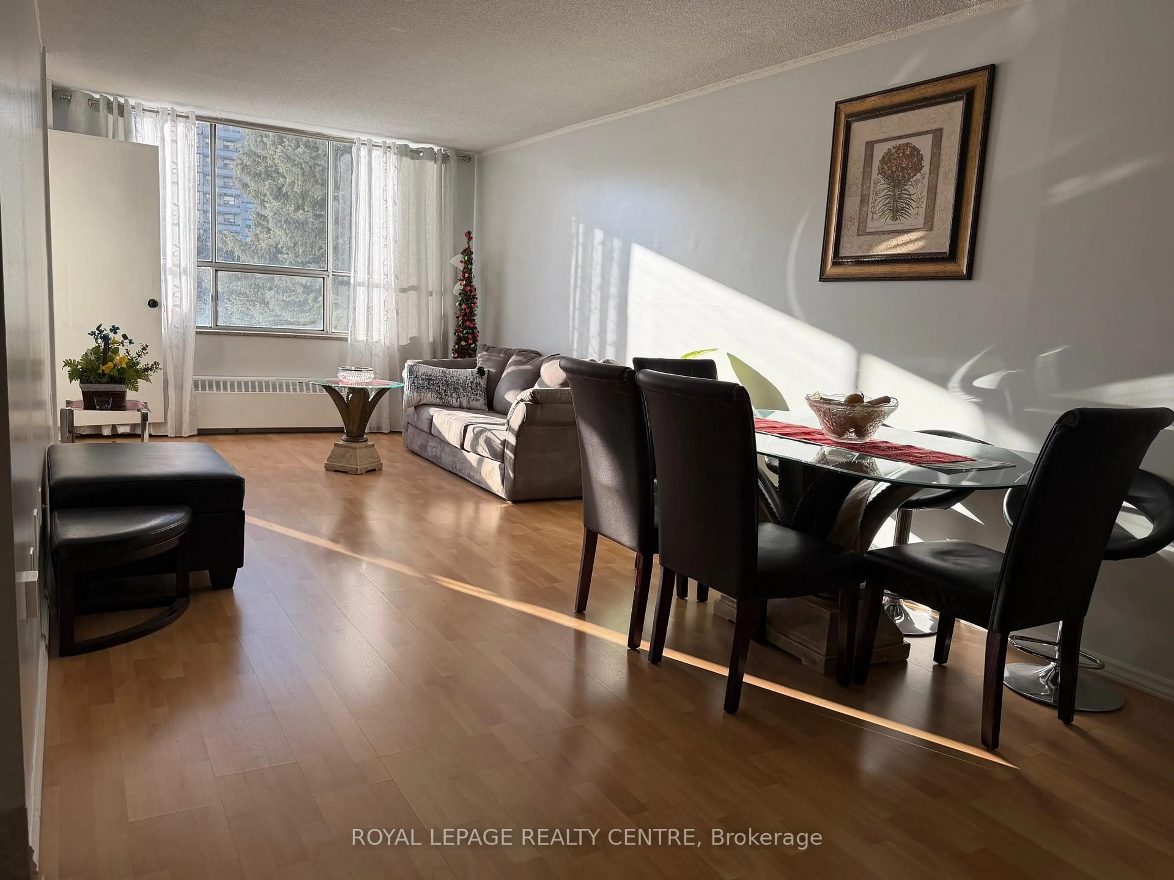 Living room with furniture, wood/laminate floor for 340 Dixon Rd #209, Toronto Ontario M9R 1T1