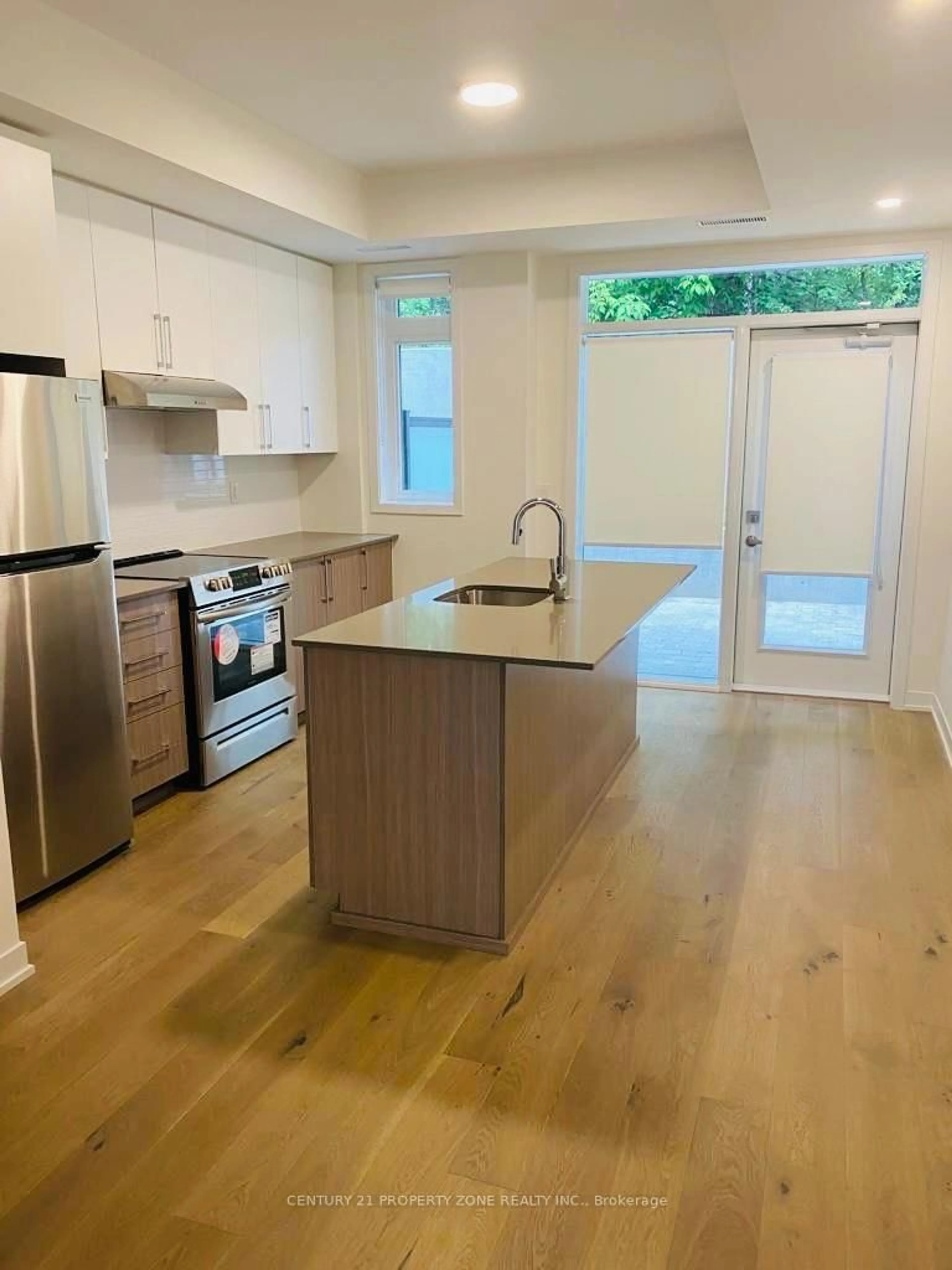 Open concept kitchen, wood/laminate floor for 110 Canon Jackson Dr #102, Toronto Ontario M6M 0C1