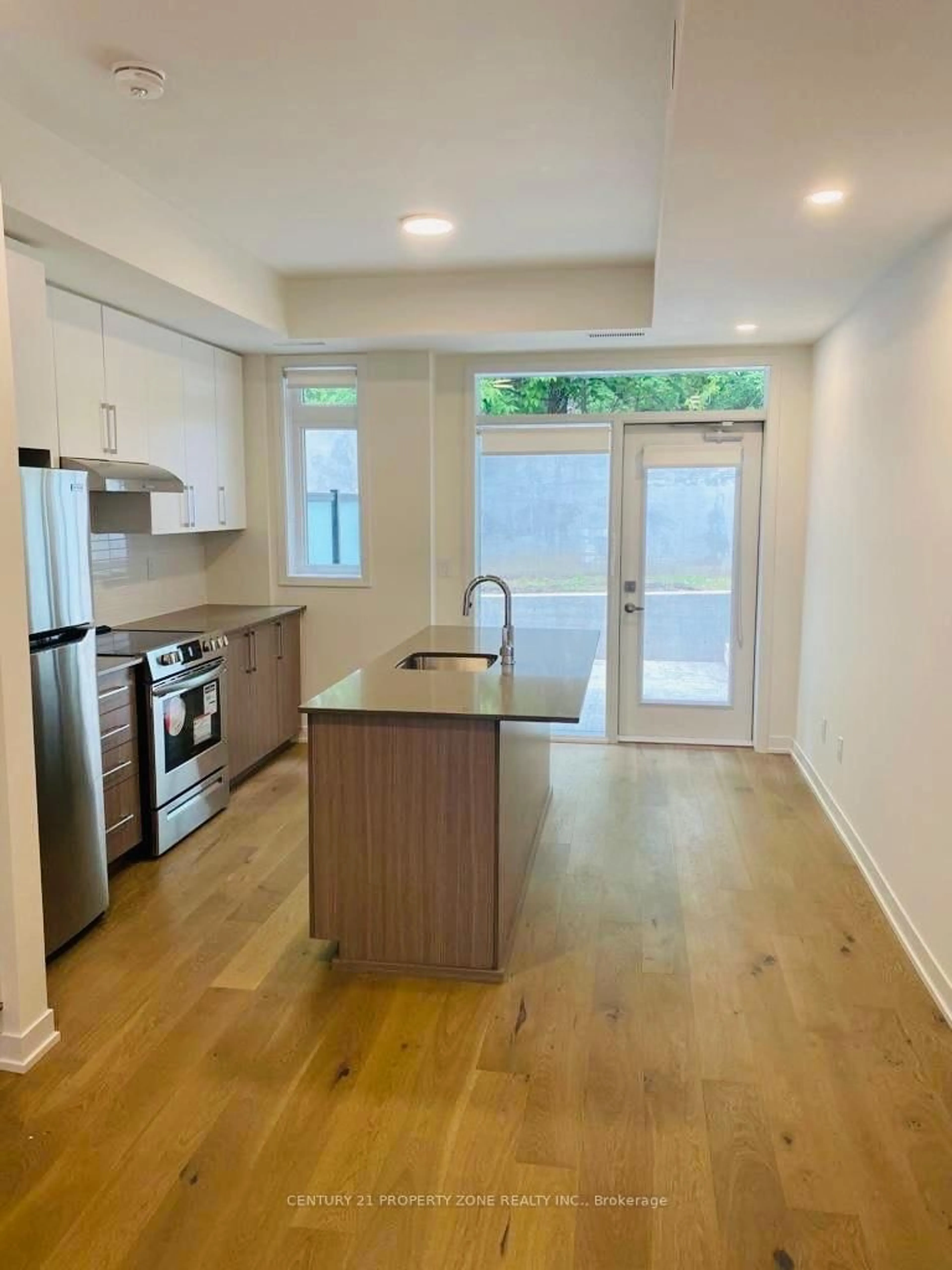 Open concept kitchen, wood/laminate floor for 110 Canon Jackson Dr #102, Toronto Ontario M6M 0C1