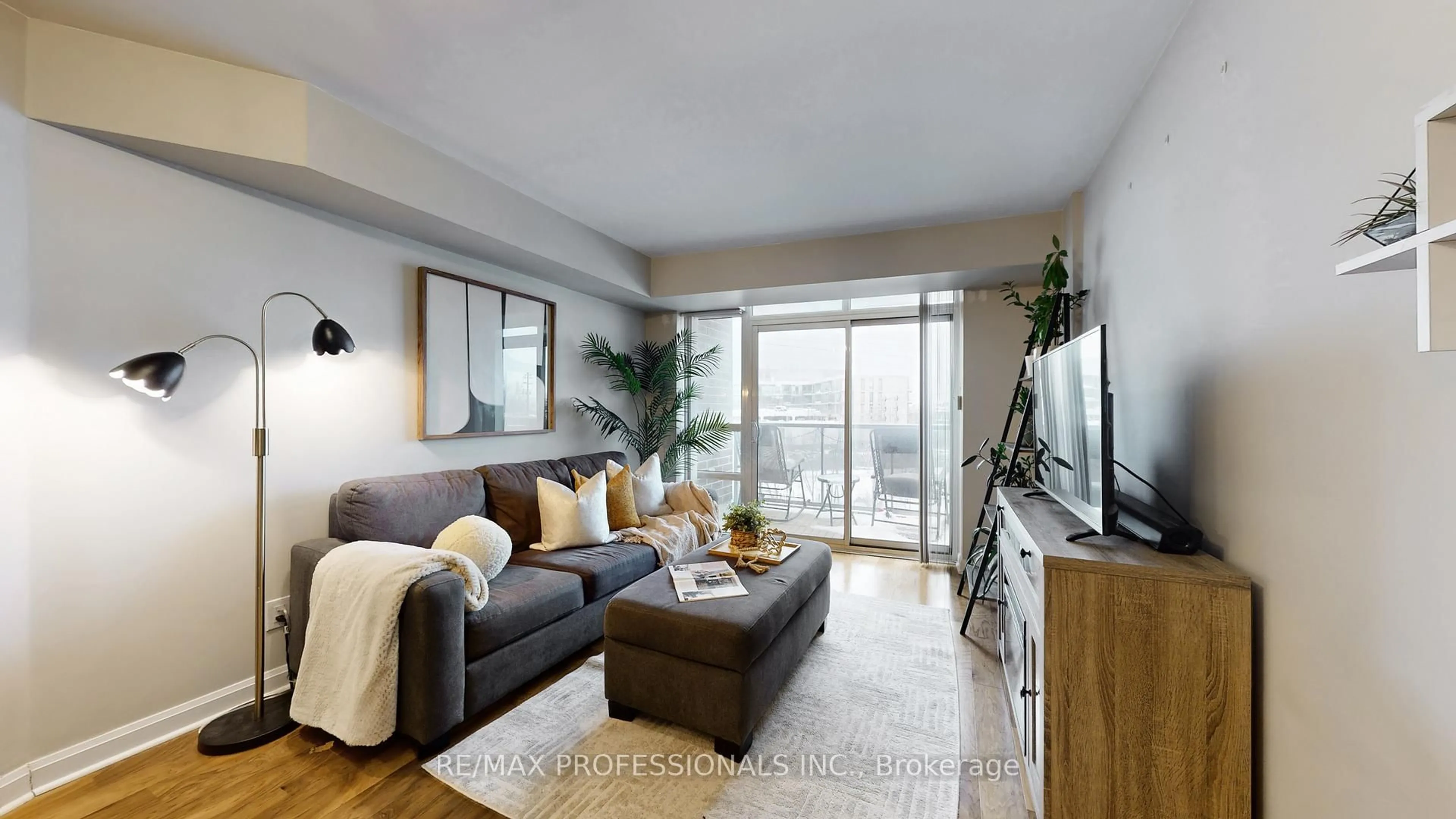 Living room with furniture, wood/laminate floor for 1 Michael Power Pl #305, Toronto Ontario M9A 0A1