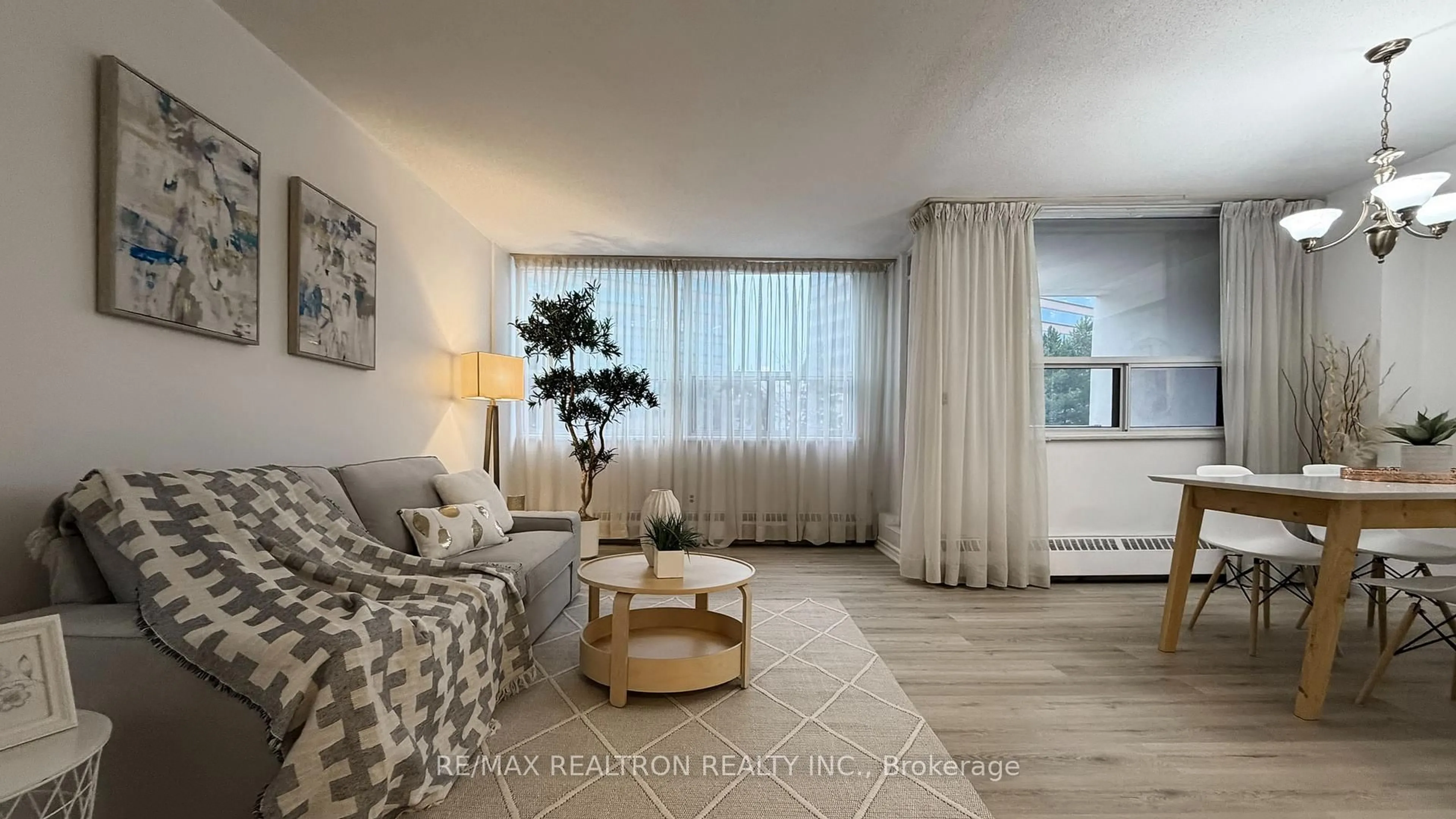 Living room with furniture, wood/laminate floor for 451 The West Mall #218, Toronto Ontario M9C 1G1