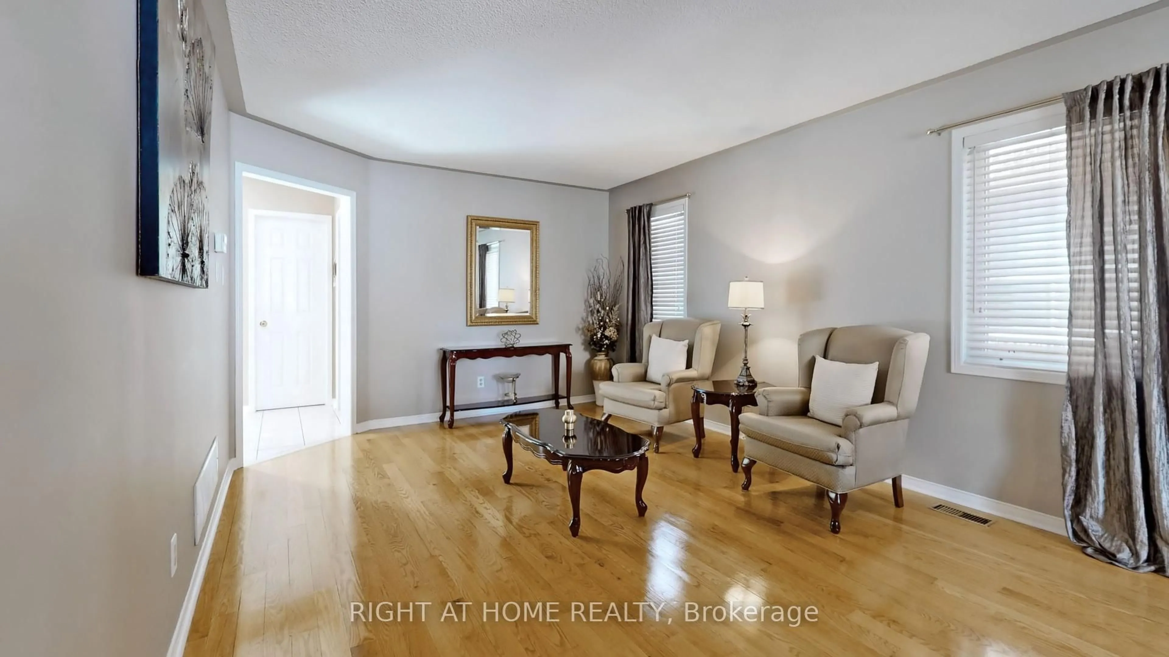 Living room with furniture, wood/laminate floor for 102 Mullis Cres, Brampton Ontario L6Y 4T1