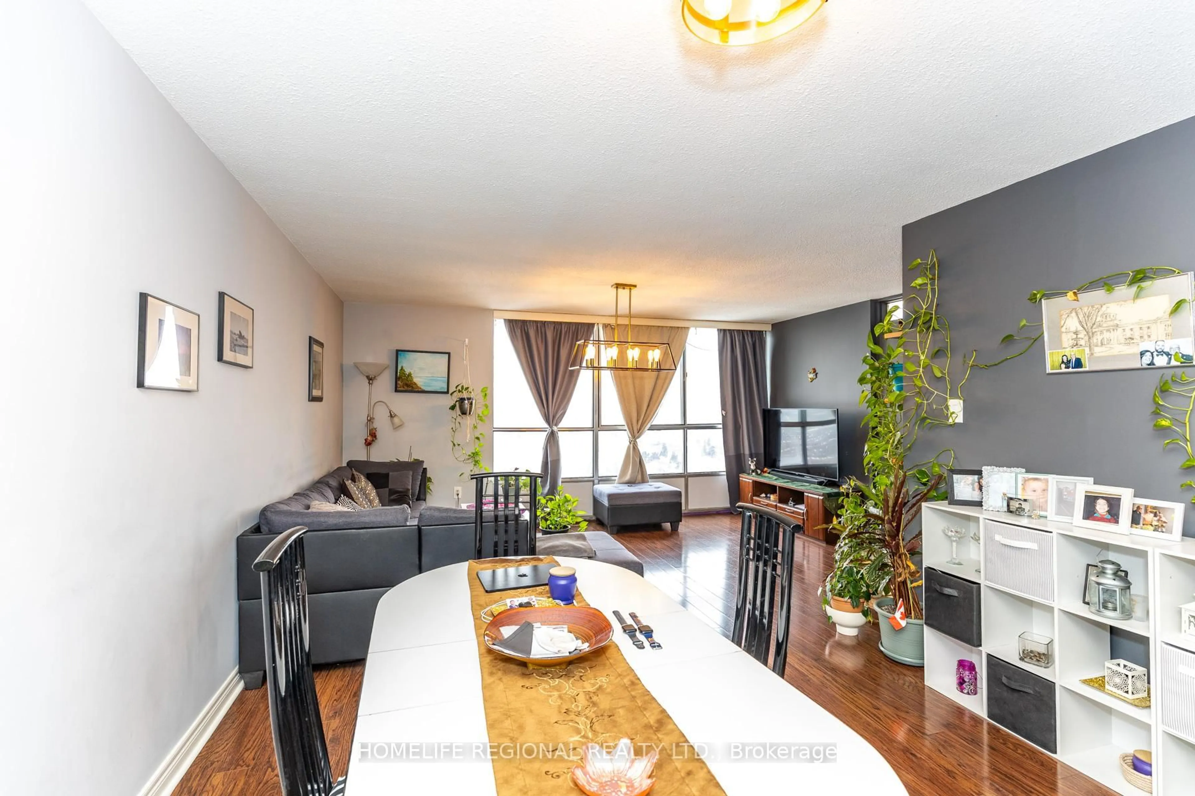 Living room with furniture, wood/laminate floor for 10 Martha Eaton Way #PH14-2414, Toronto Ontario M6M 5B3