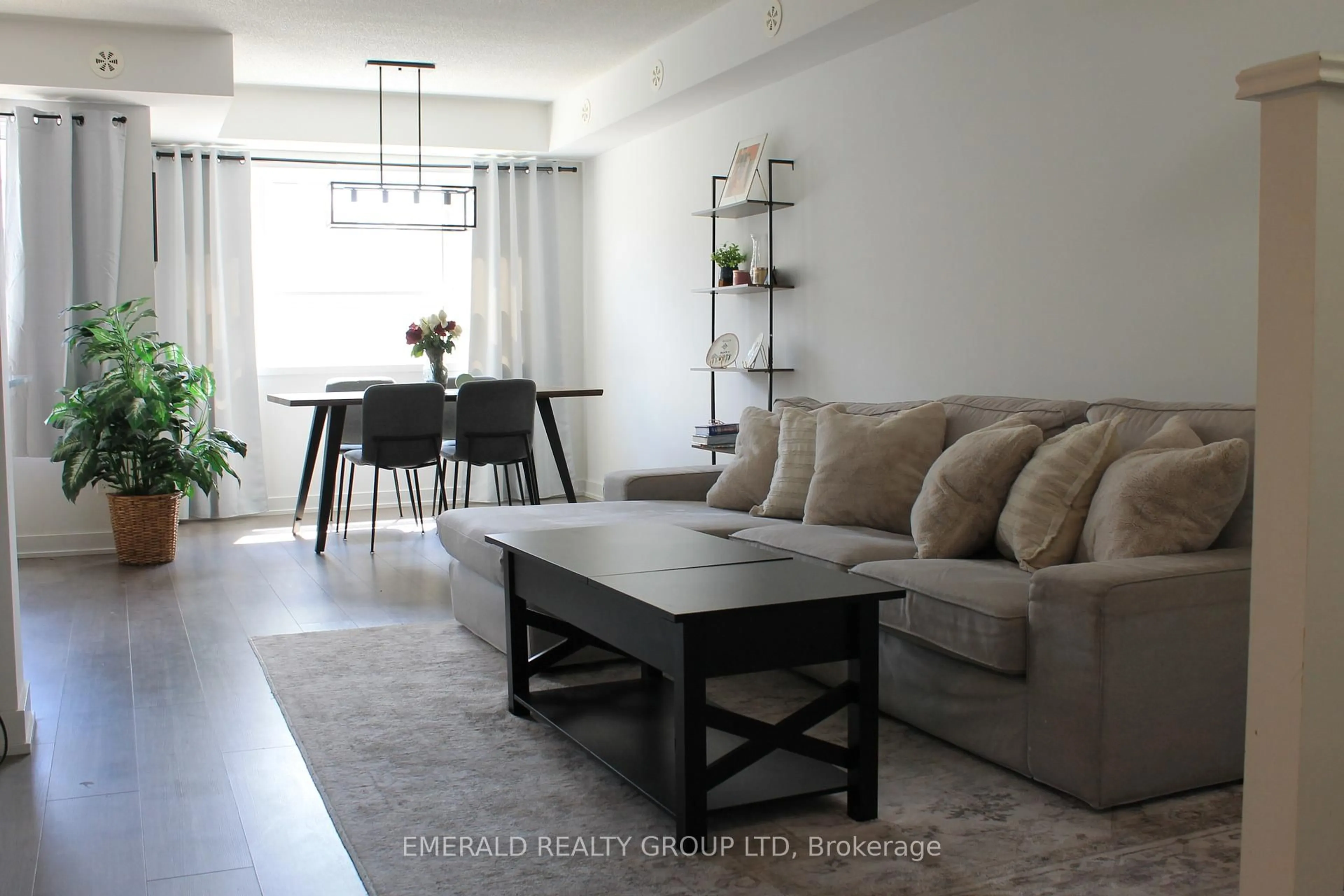 Living room with furniture, wood/laminate floor for 1127 Cooke Blvd #507, Burlington Ontario L5M 7C5