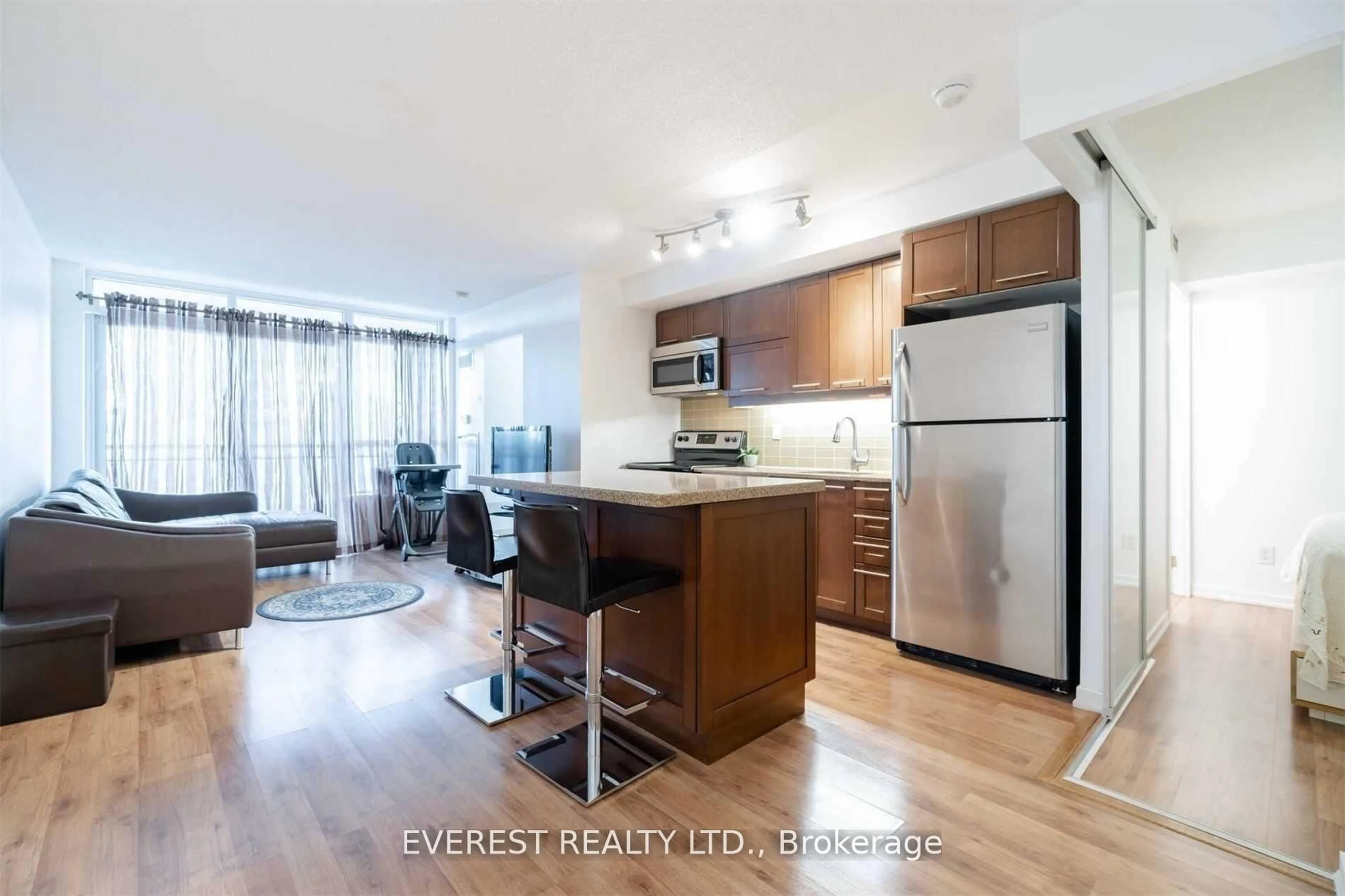 Open concept kitchen, wood/laminate floor for 38 Joe Shuster Way #1025, Toronto Ontario M6K 0A5