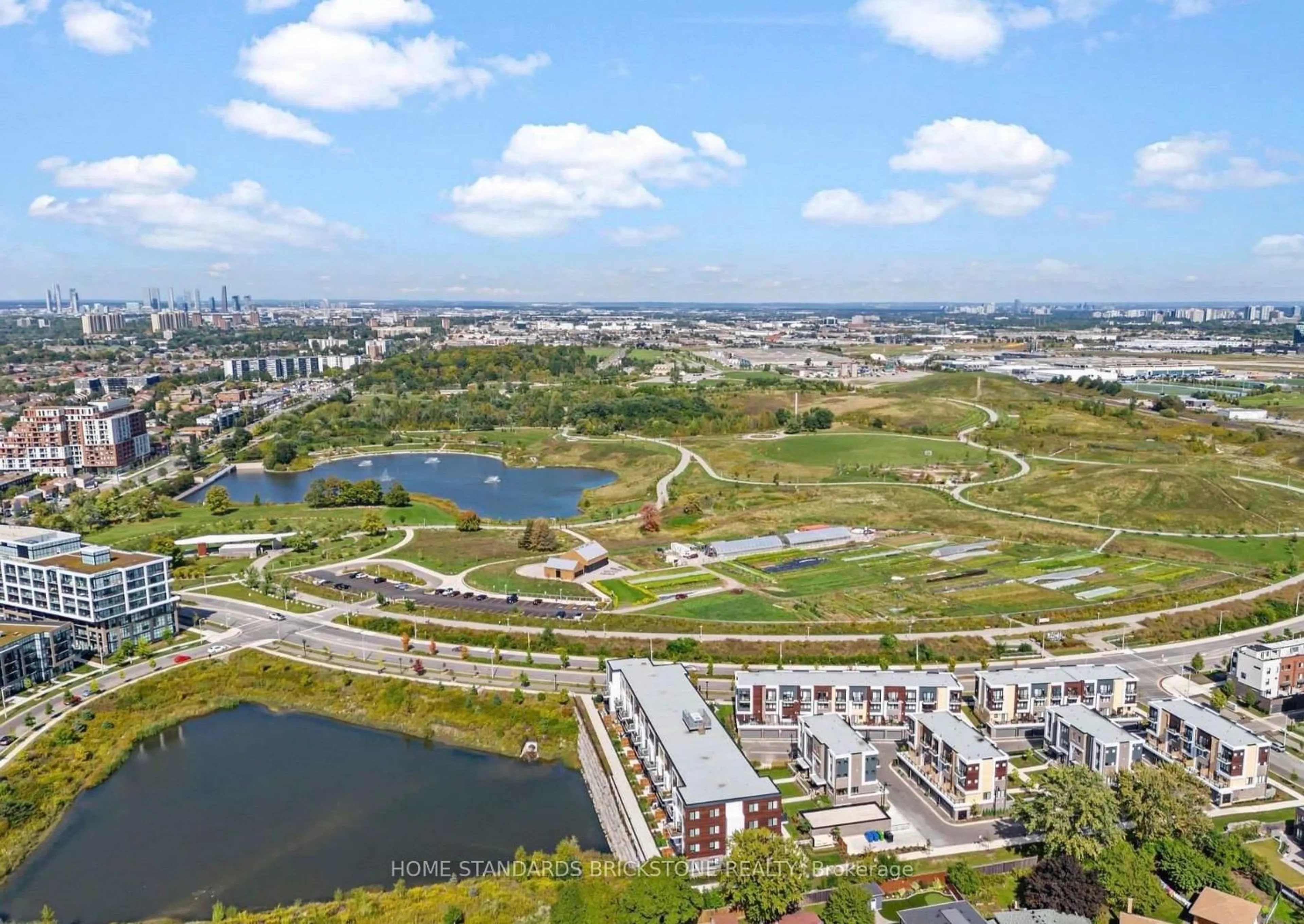 A pic from outside/outdoor area/front of a property/back of a property/a pic from drone, water/lake/river/ocean view for 155 Downsview Park Blvd #207, Toronto Ontario M3K 0E3