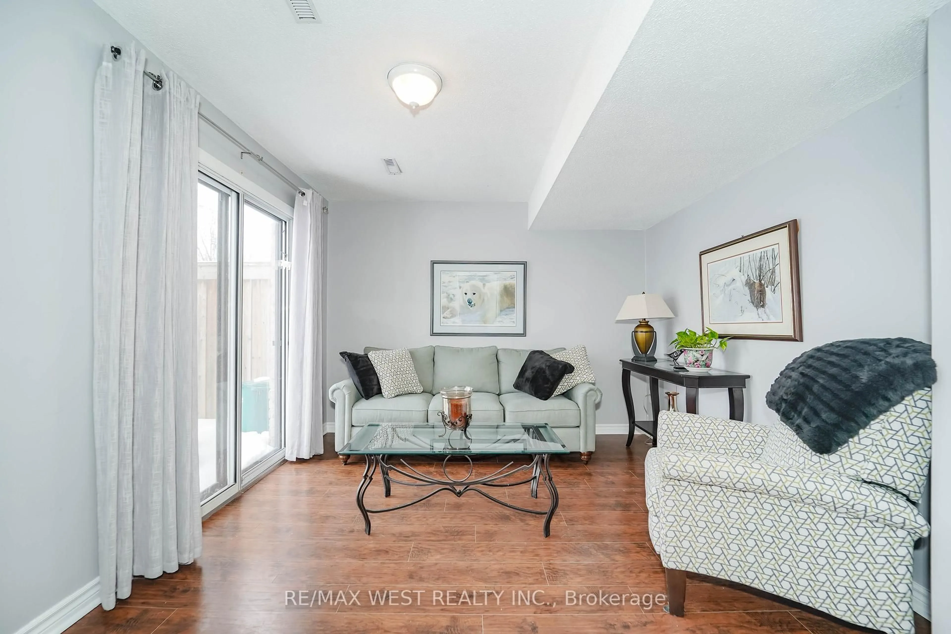 Living room with furniture, wood/laminate floor for 7340 Copenhagen Rd #24, Mississauga Ontario L5N 2S5